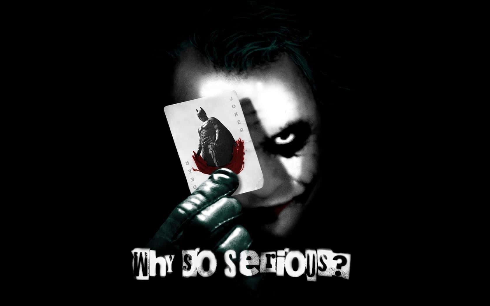 Joker Holding A Card With A Why So Serious Quote Wallpaper