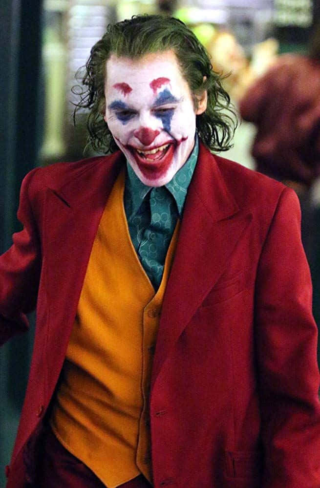 Joker Laughing Maniacally - Intense and Dark Moment Wallpaper