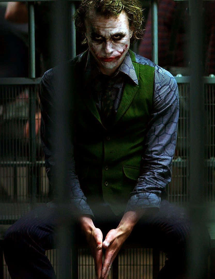 Joker Pfp Sitting In Jail Wallpaper