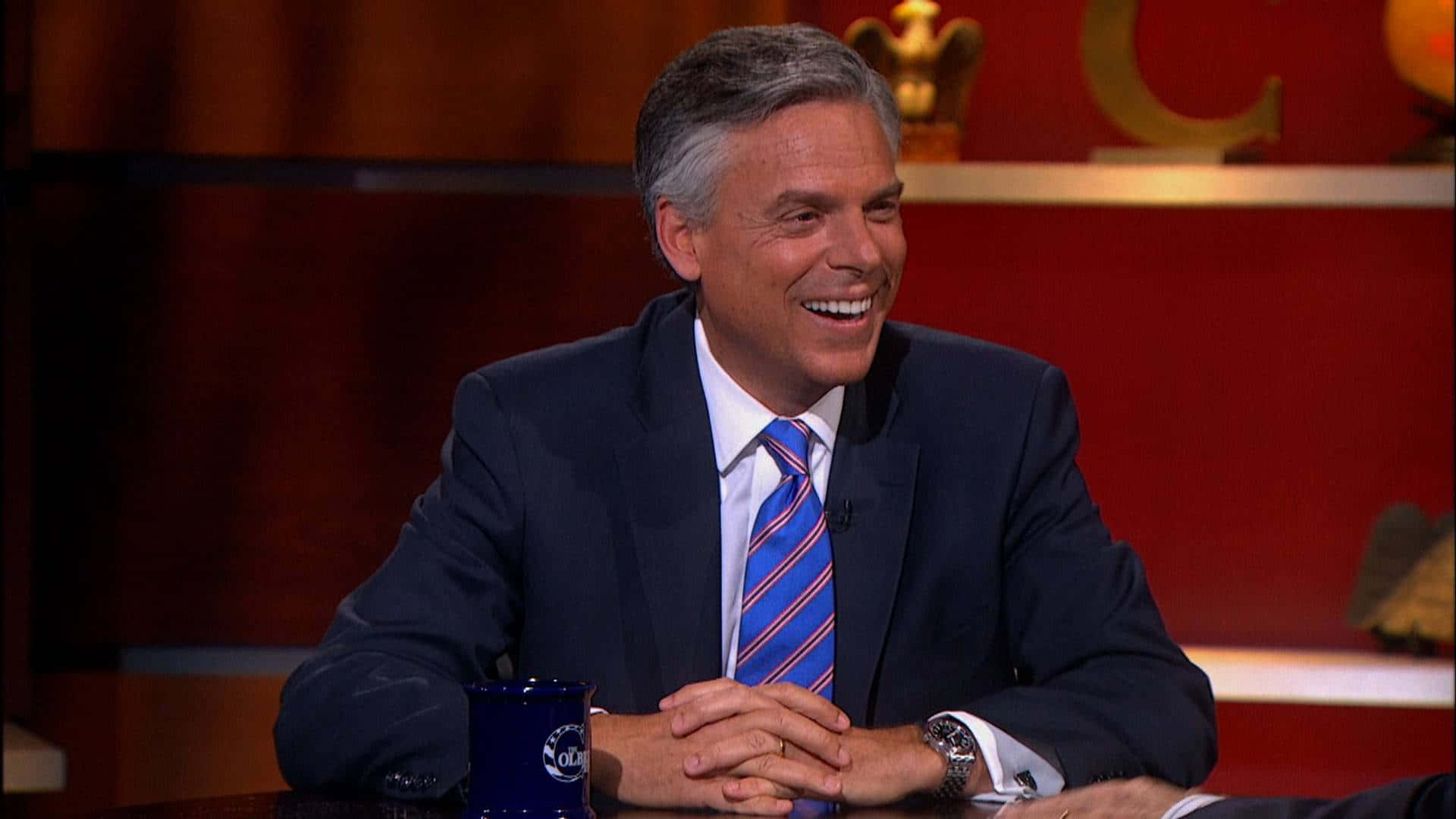 Jon Huntsman with entwined fingers in thought Wallpaper
