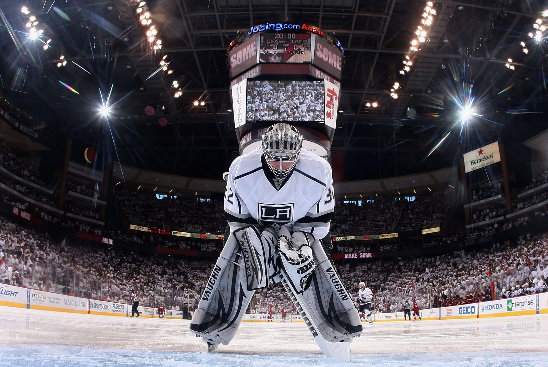 A Hockey Goalie Is Standing In Front Of A Crowd Wallpaper