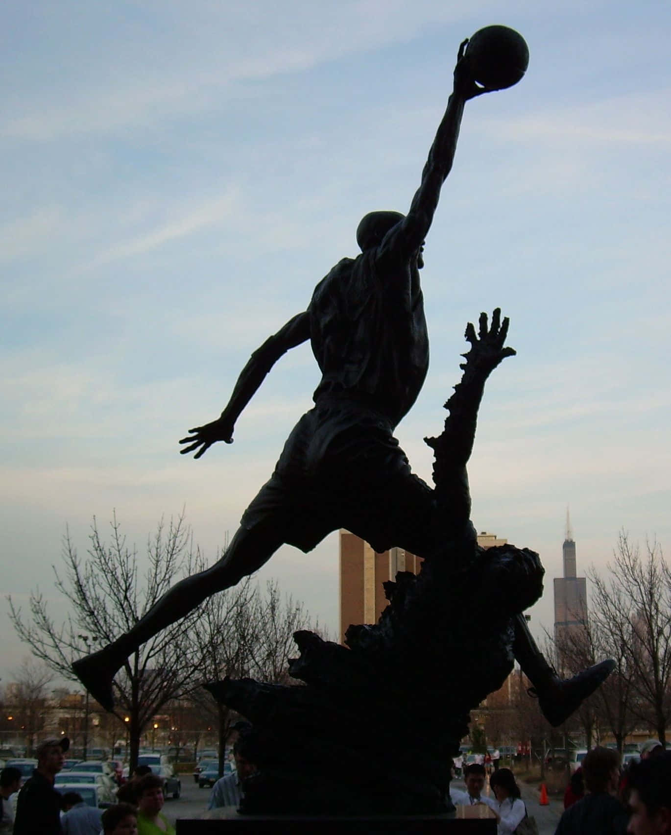 En statue af en basketballspiller hænger på væggen Wallpaper