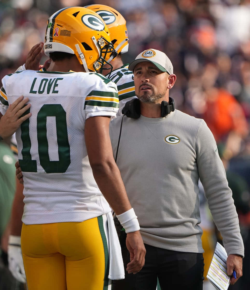 Jordan Love Green Bay Packers Sideline Interaction Wallpaper