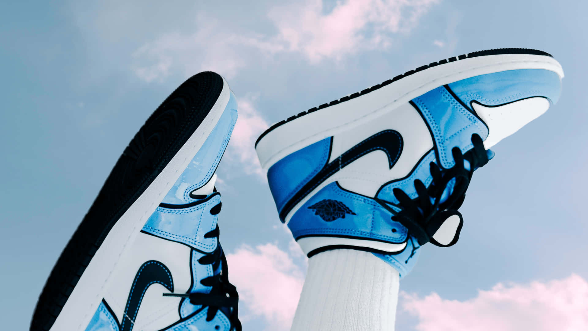 Et par blå og hvide sneakers med skyer i himlen Wallpaper