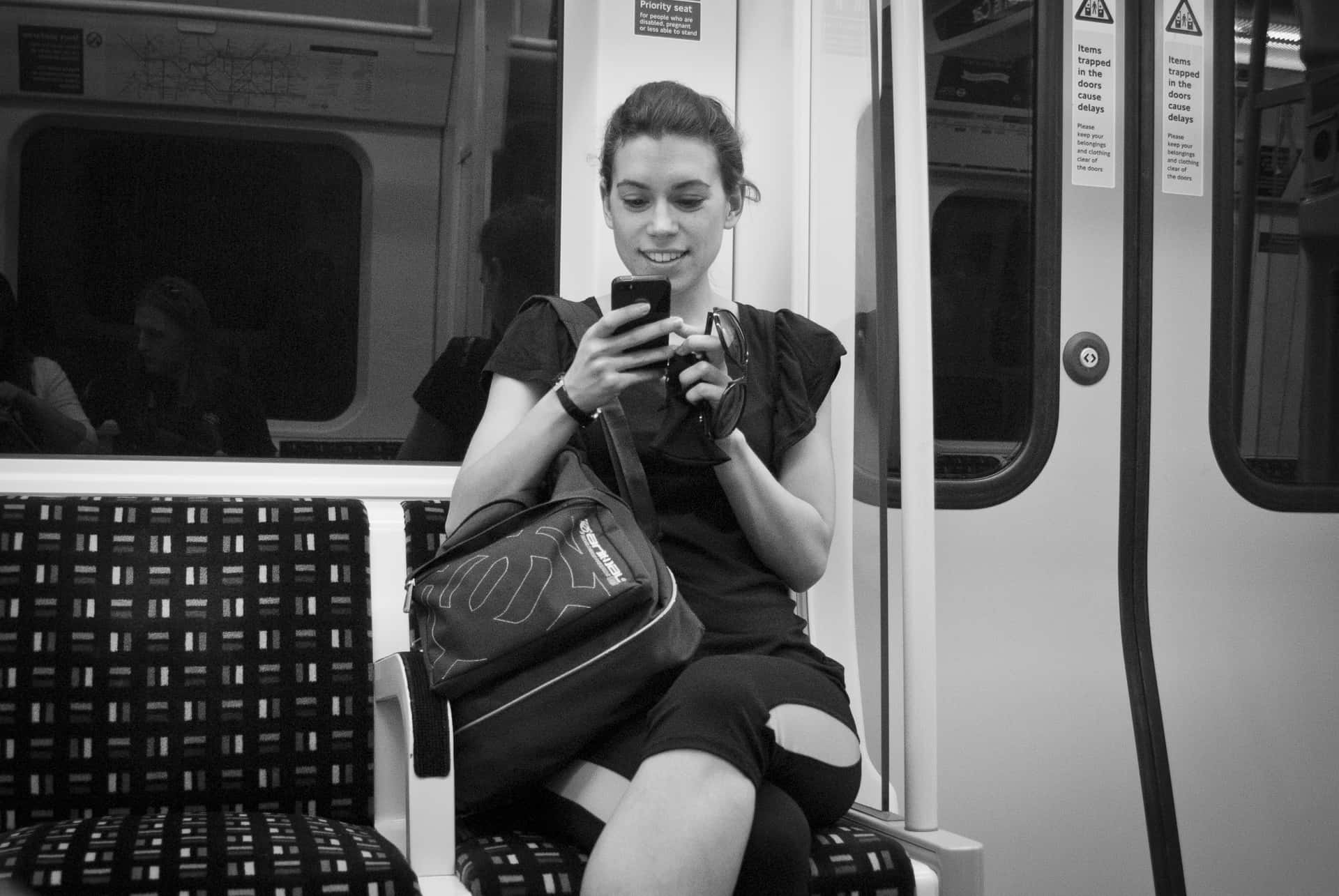 Jovial Woman Reading A Text Wallpaper