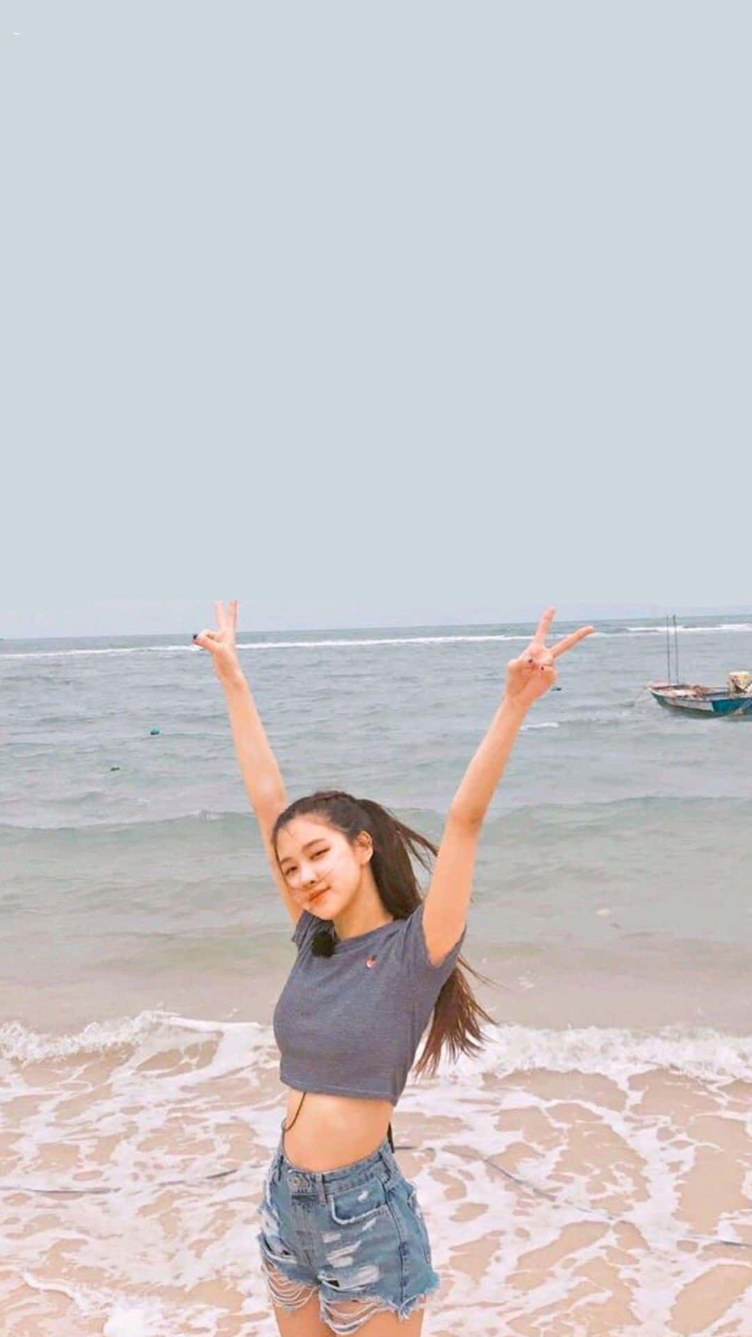 Joyful Beach Girl Victory Pose Wallpaper