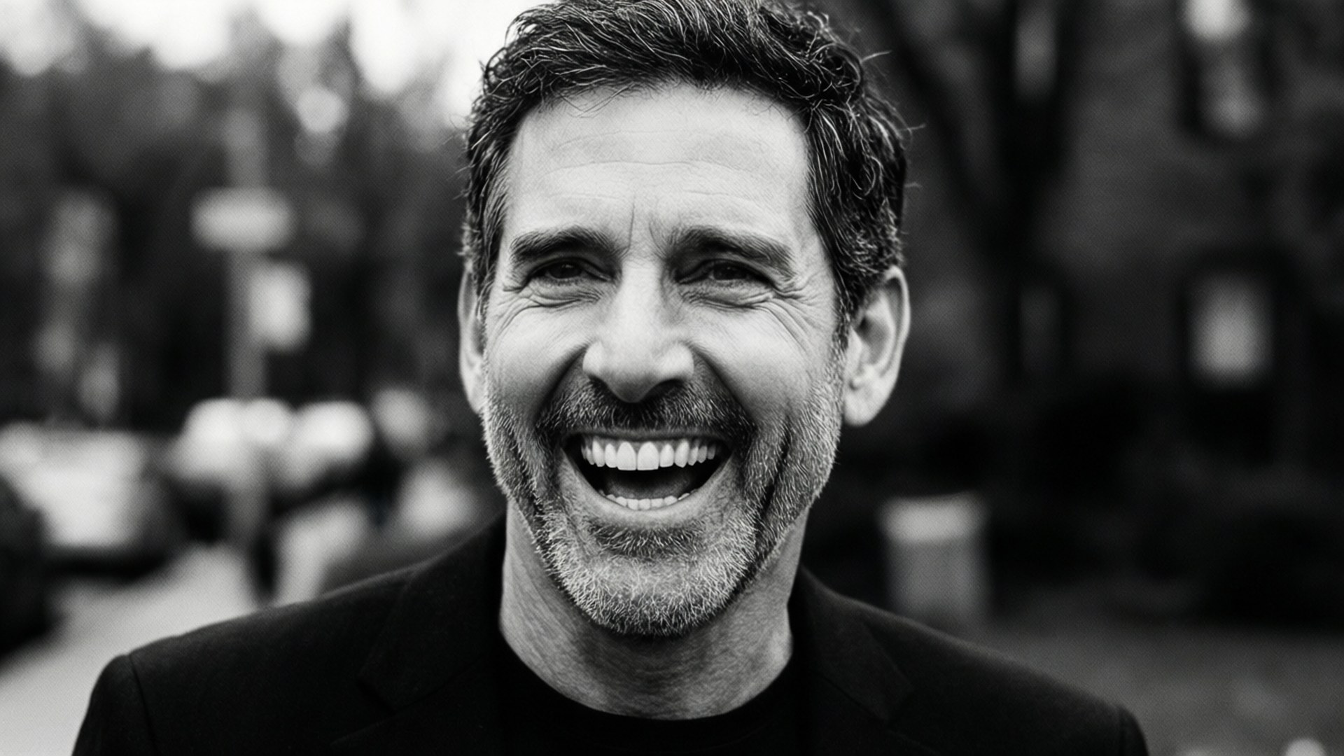 Steve Carell laughing candidly, black and white