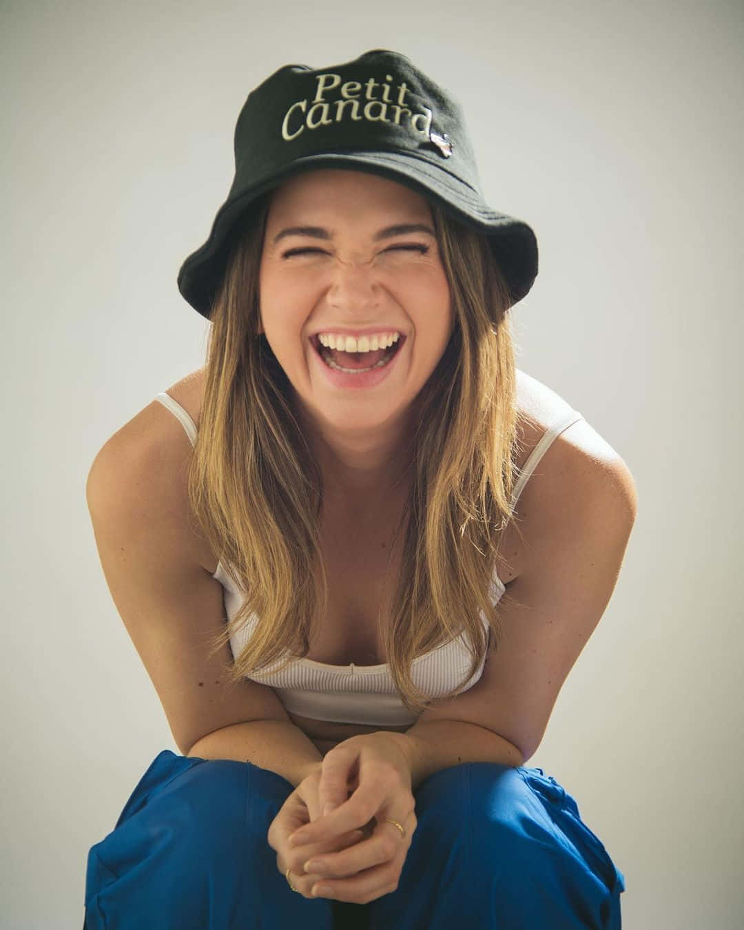 Joyful Woman Laughingin Bucket Hat Wallpaper