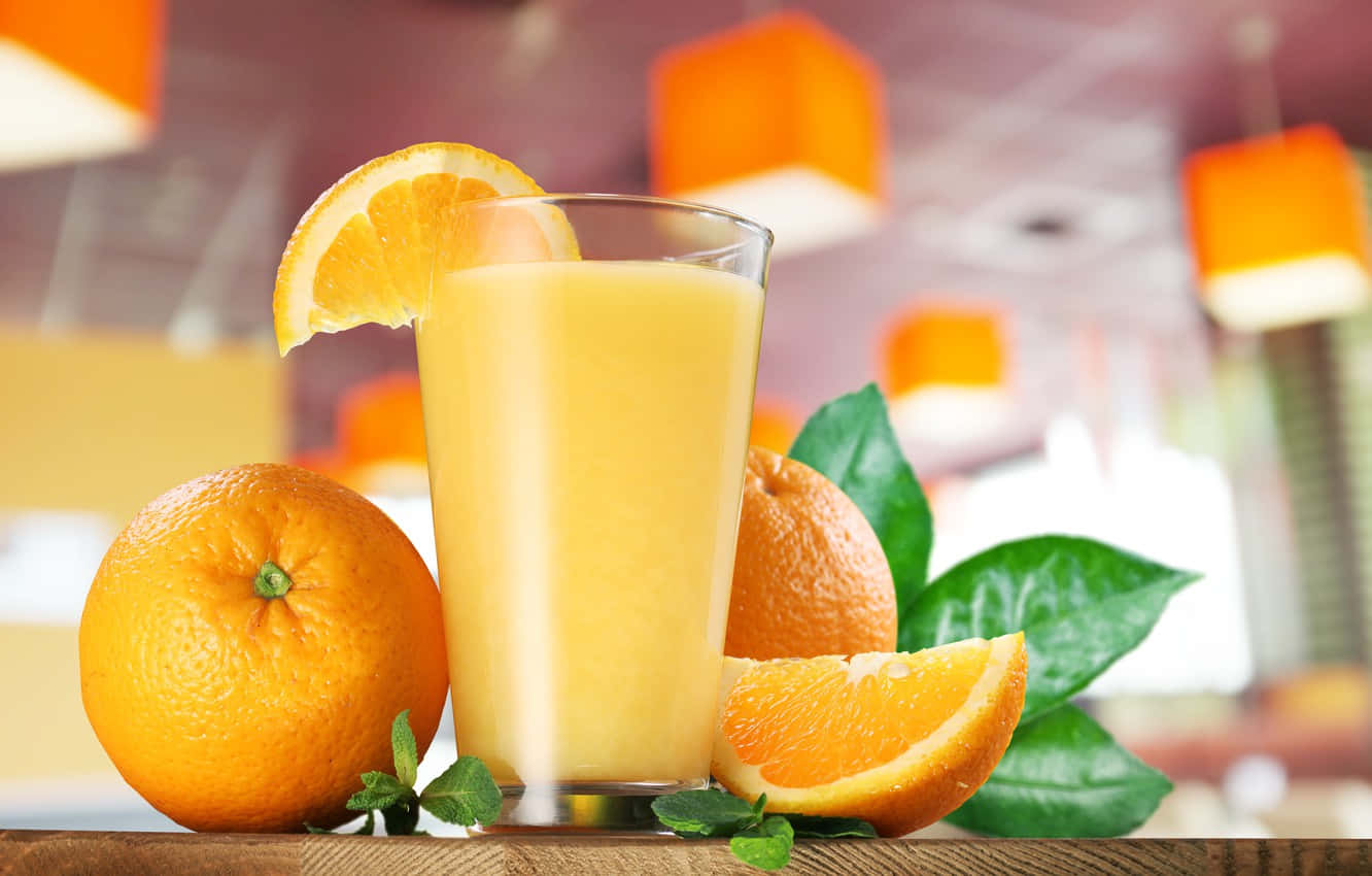 Juice With Orange Fruits And Leaves Wallpaper
