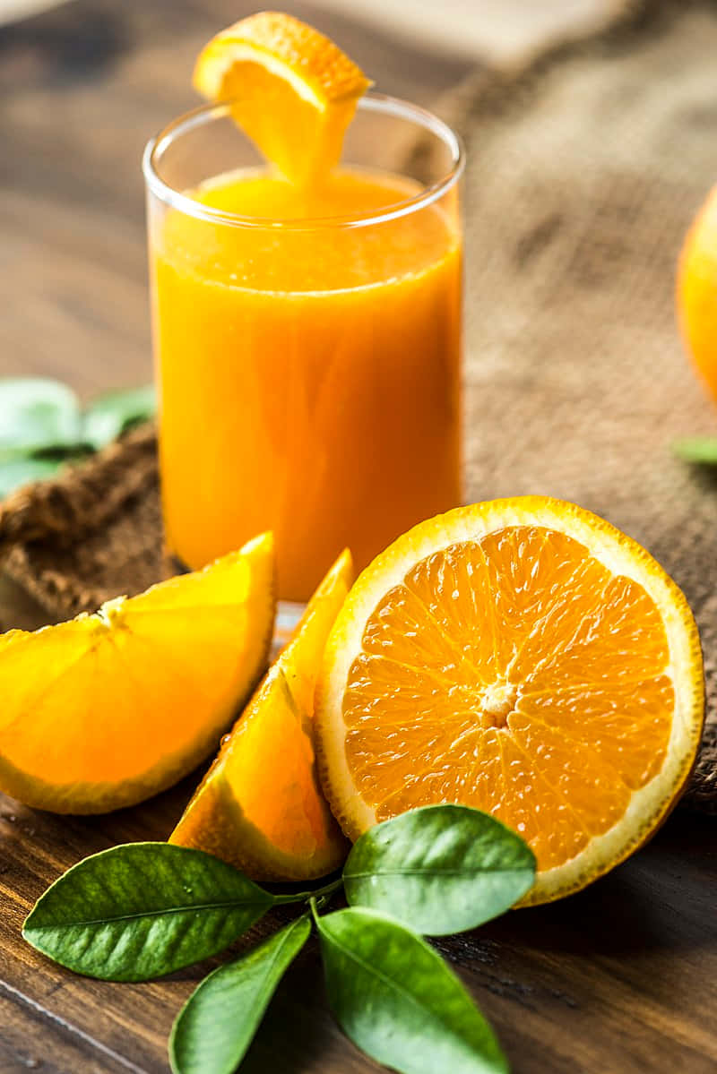 Juice With Orange Wedge And Wheel Slices Wallpaper