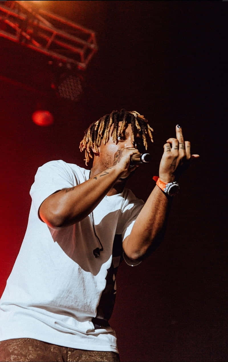 Juice Wrld playing an electrifying show at a concert Wallpaper
