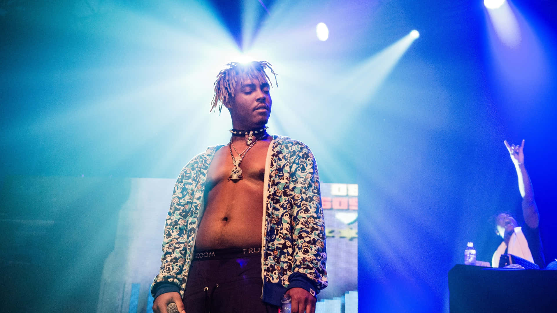 Juice Wrld electrifies the stage with his dynamic performance at a concert. Wallpaper