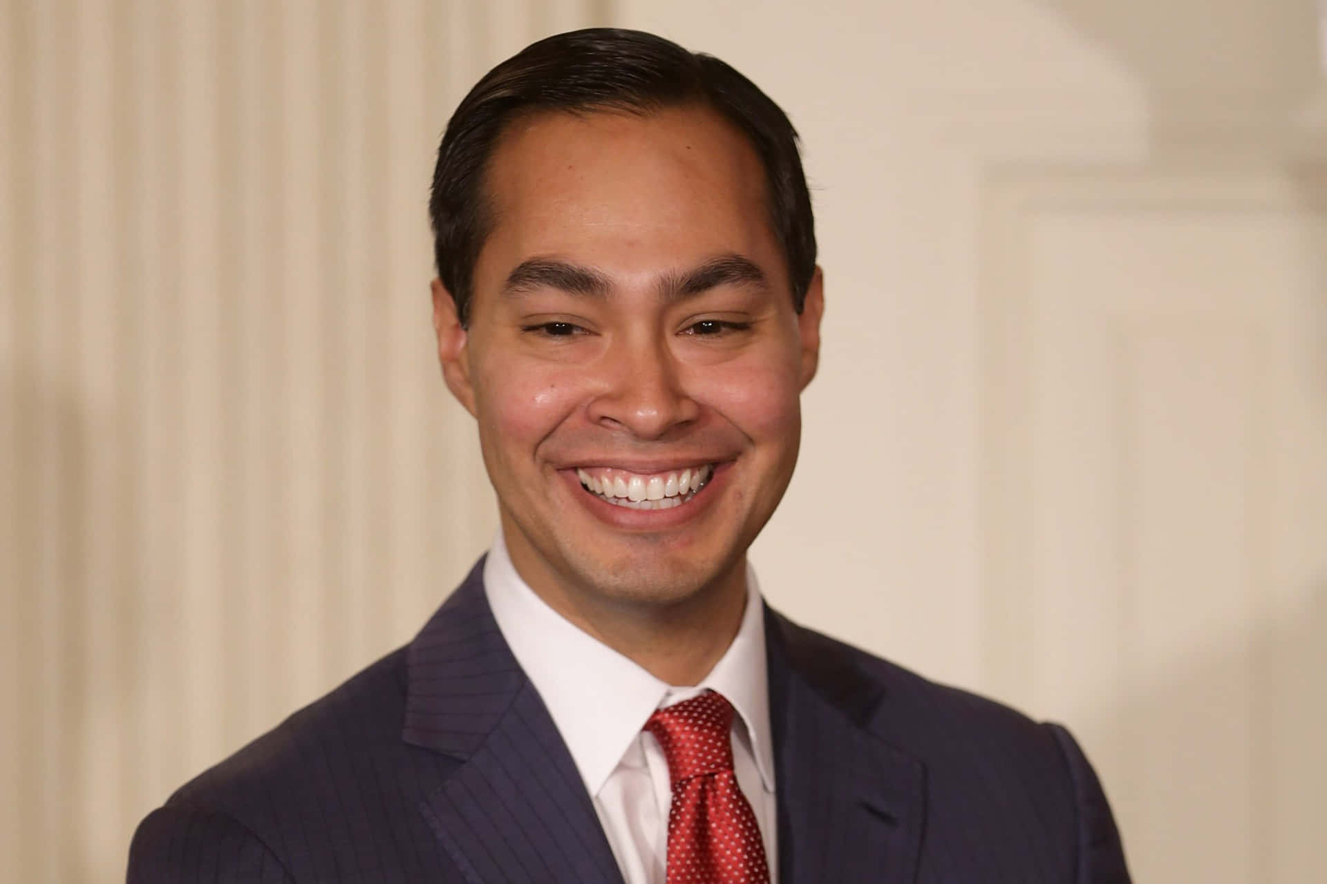Julian Castro flashes an engaging smile in a front view portrait. Wallpaper