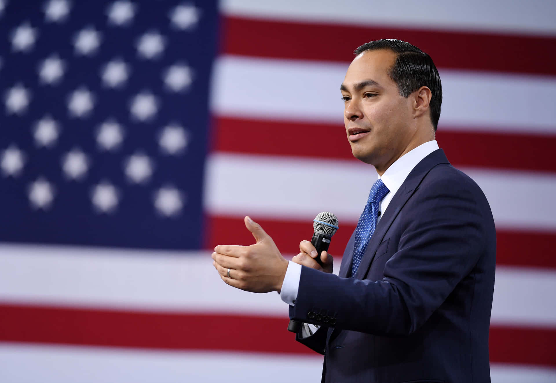 Julian Castro With American Flag Background Wallpaper