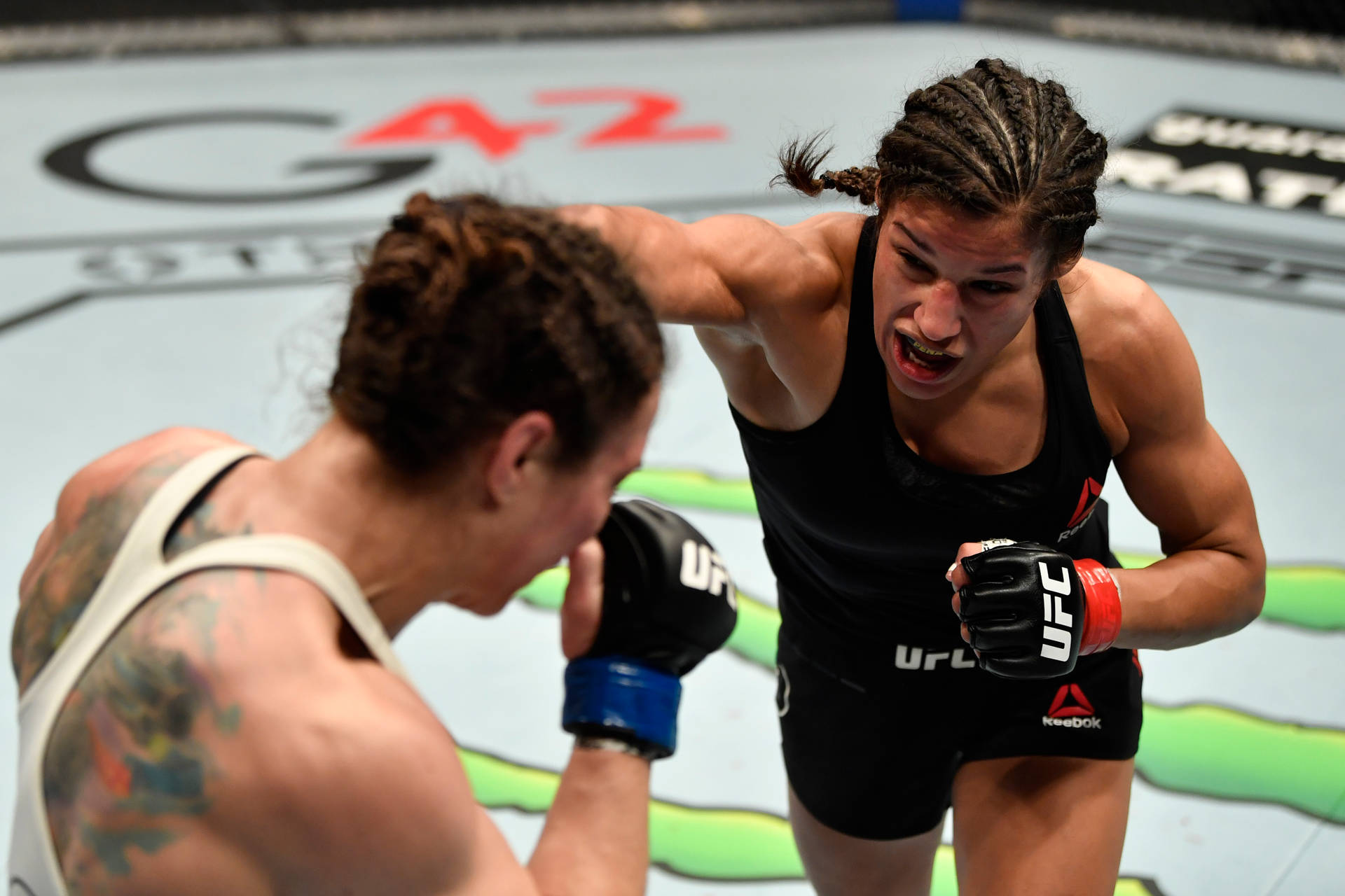 Caption: Intense Fight Moment: Julianna Peña Punching Sara McMann Wallpaper