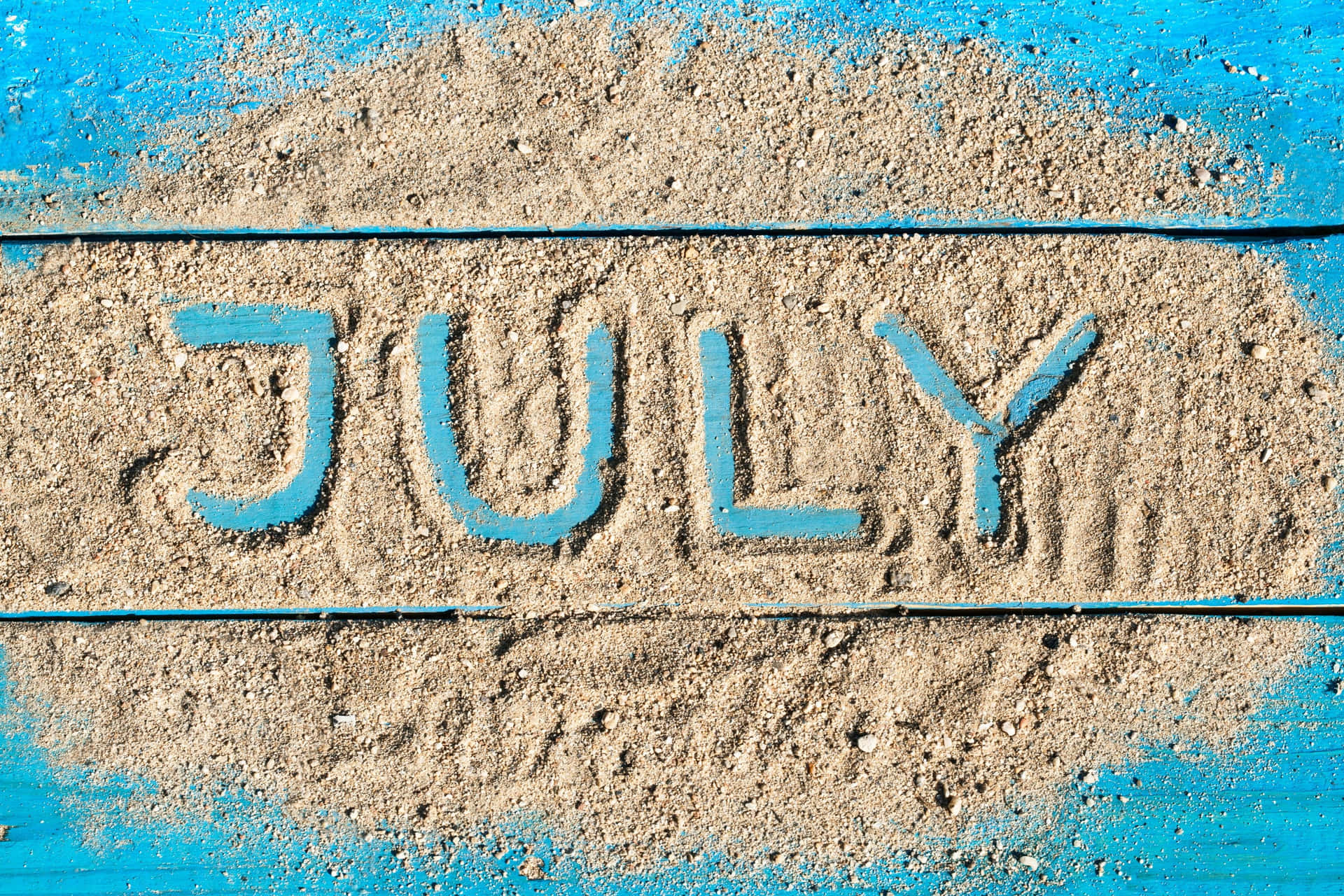 July Sand Writingon Blue Background Wallpaper