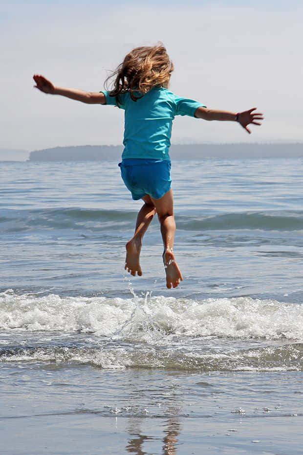 A Girl Jumping Into The Water