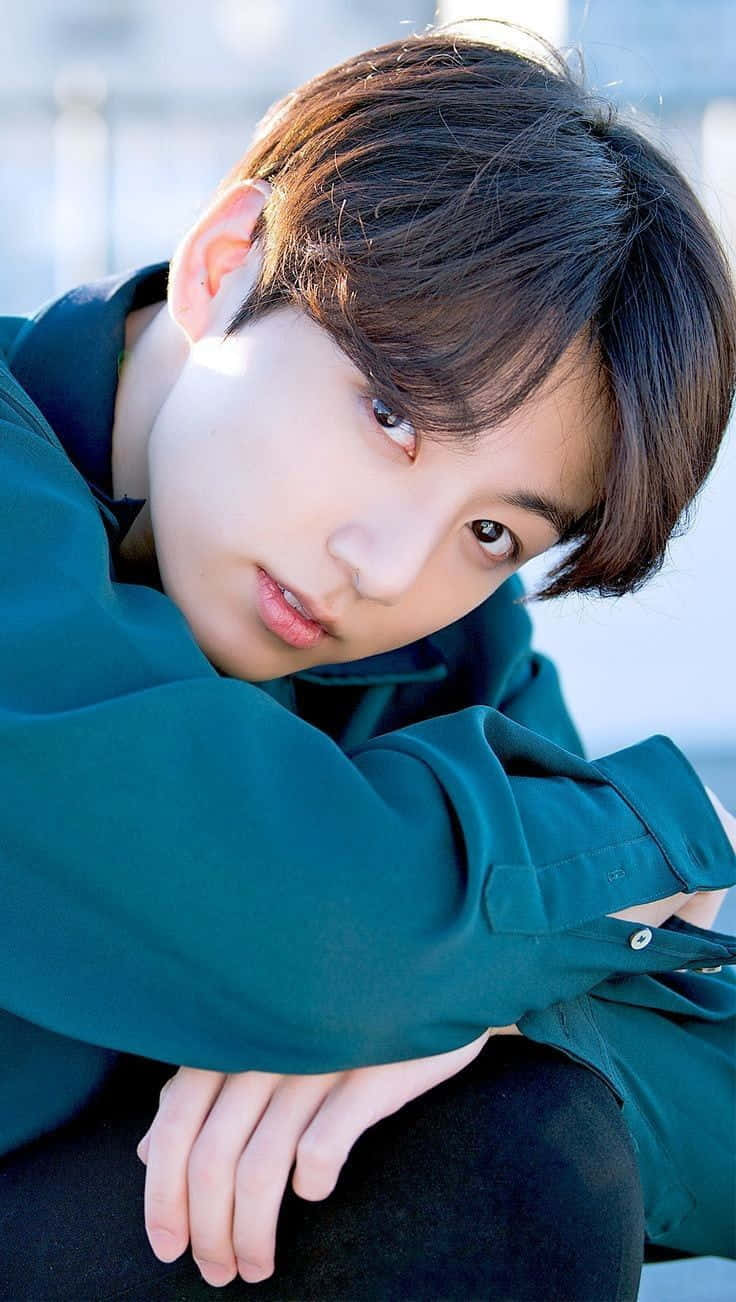 Jungkook looking stylish and captivating in this high-quality wallpaper