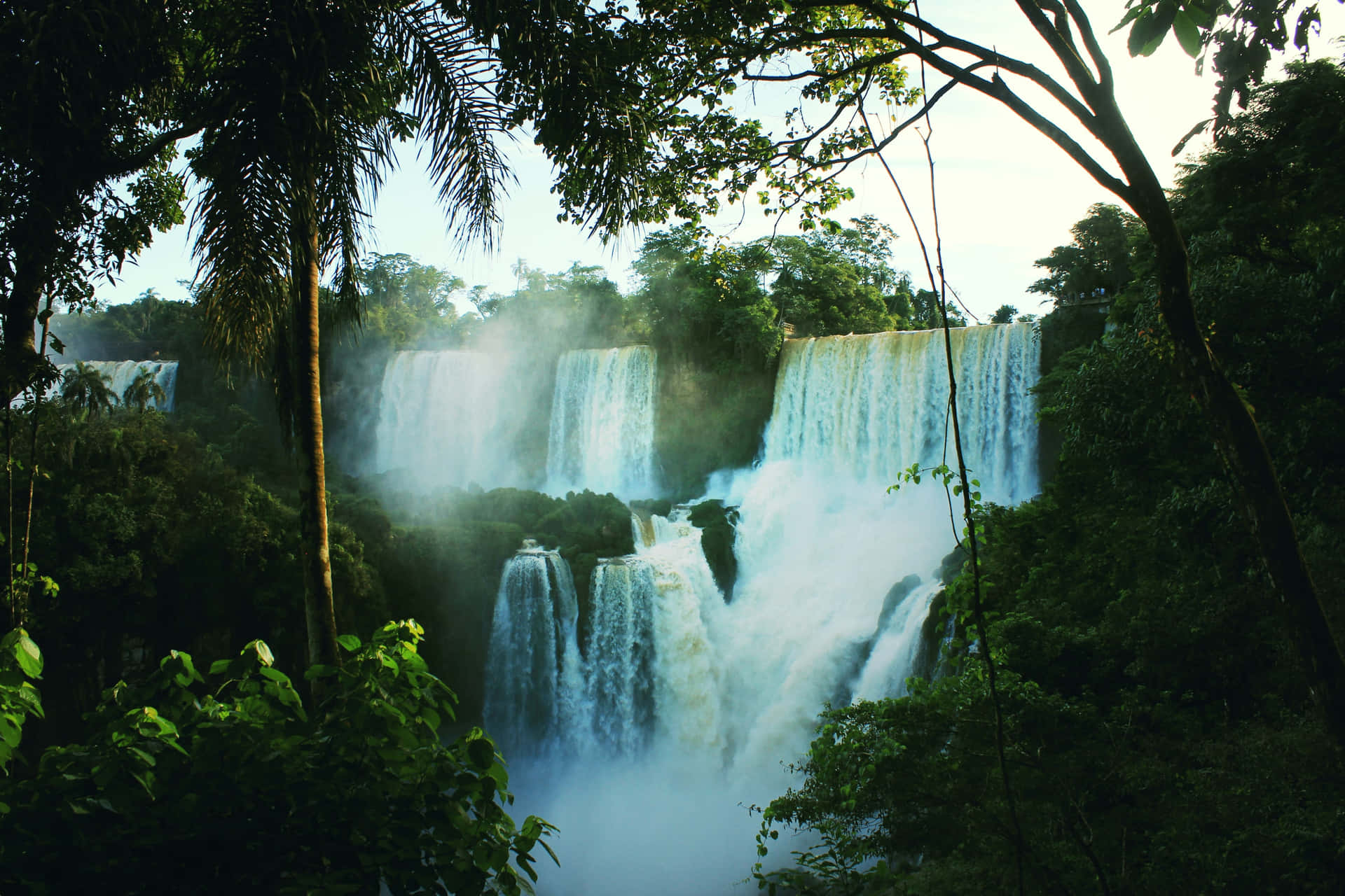 Misty Iguazu Waterfalls From Brazil Jungle Background