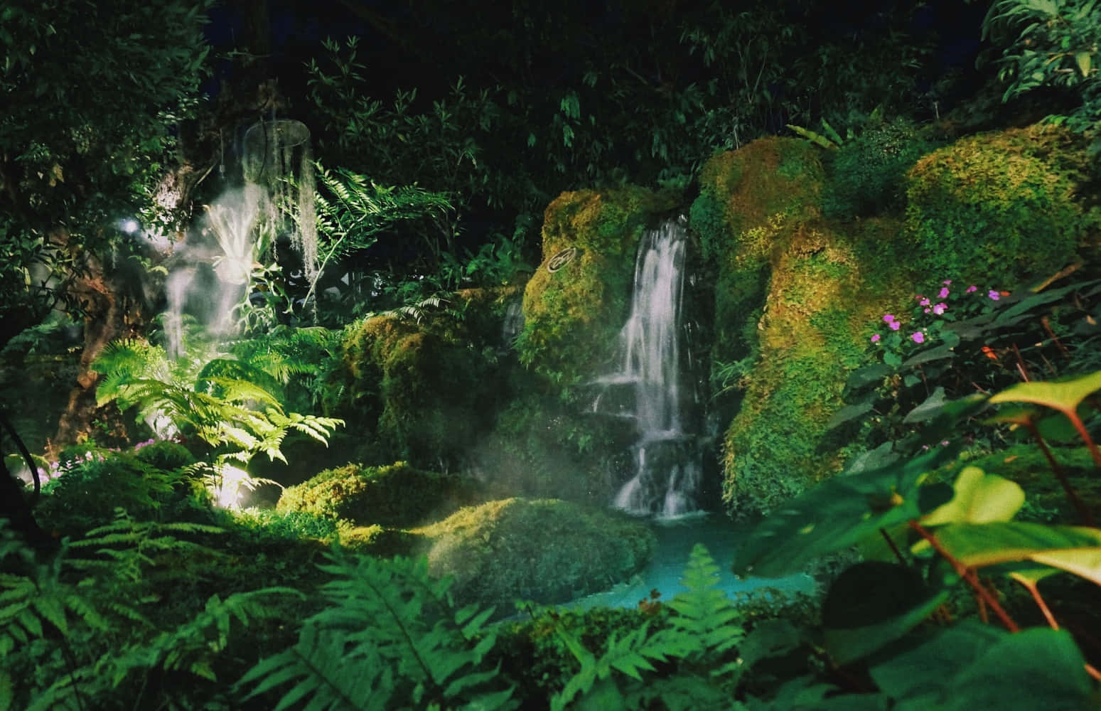 A Waterfall In A Tropical Garden At Night