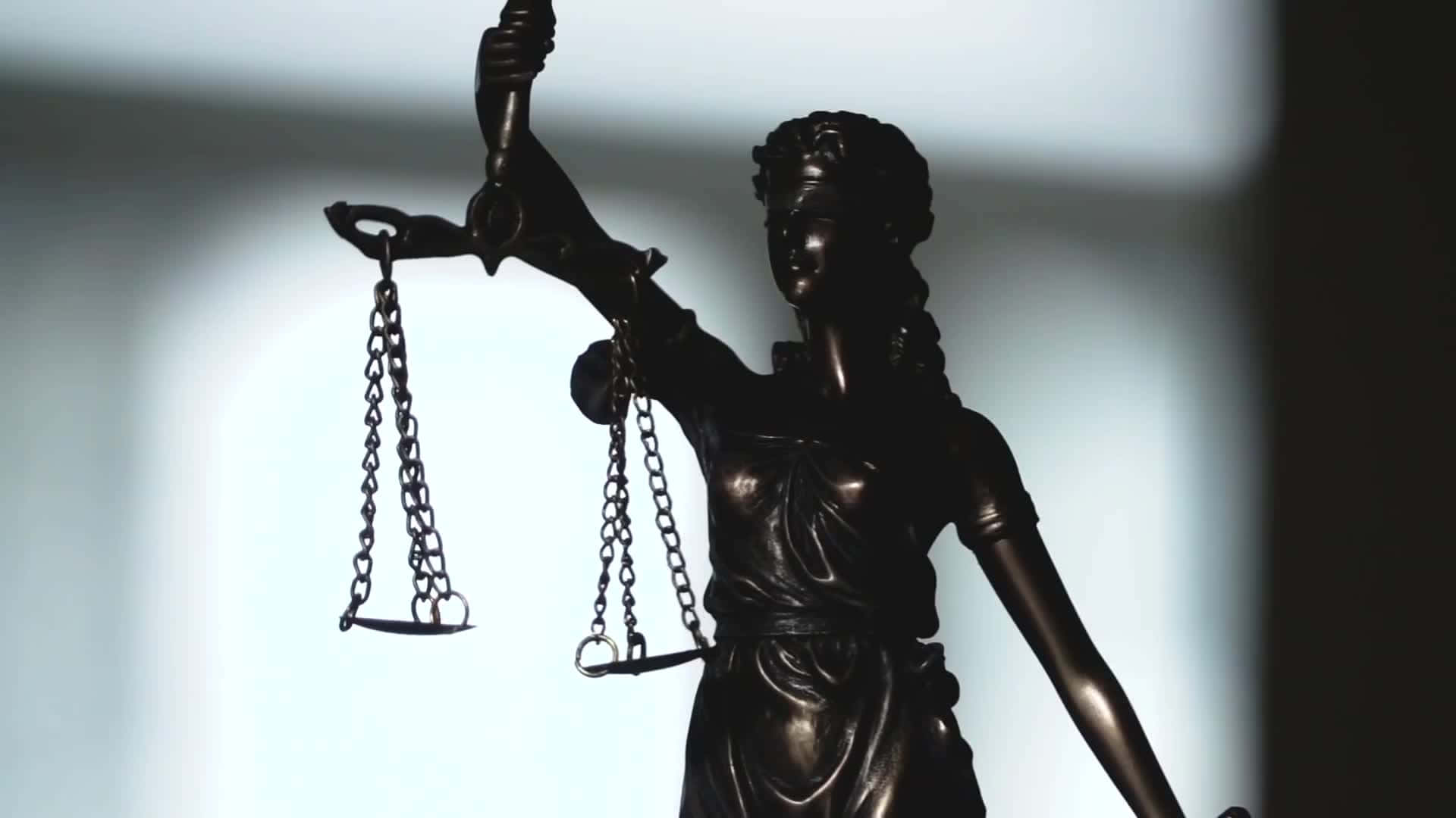 A Statue Of Justice Holding Scales