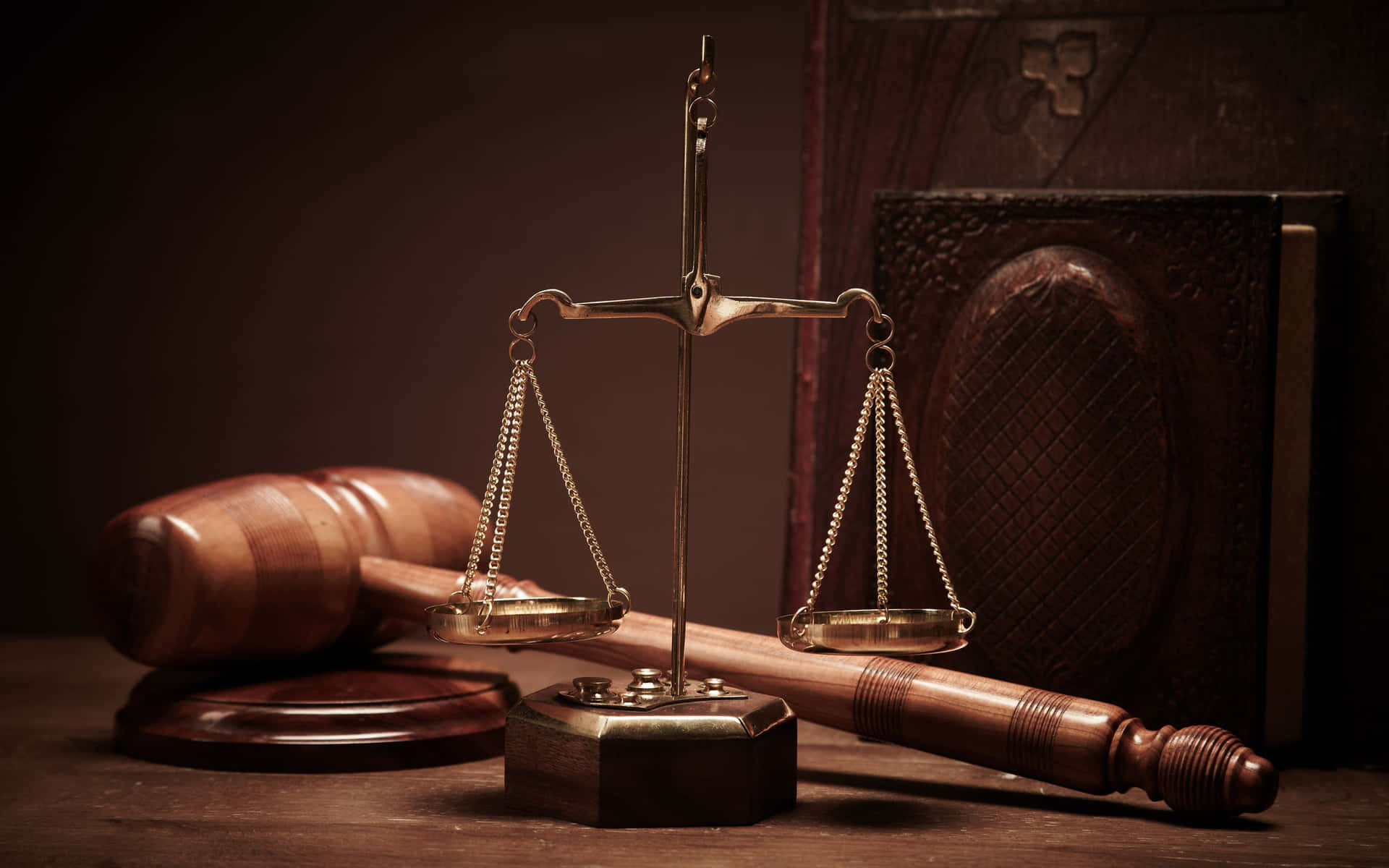 A Judge's Scale And Gavel On A Wooden Table