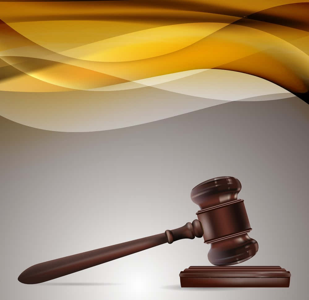 A Wooden Gavel On A Yellow Background