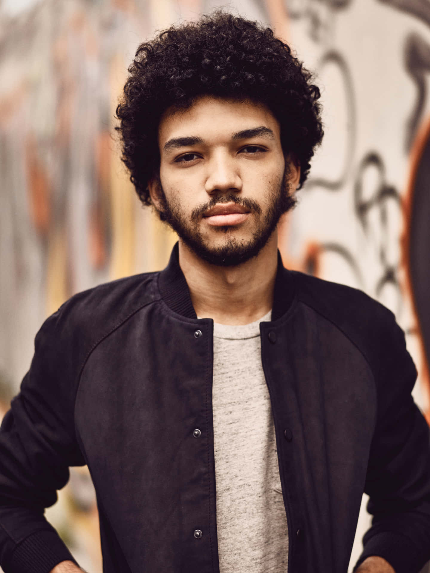 Justice Smith Posing Elegantly In A Suit Wallpaper
