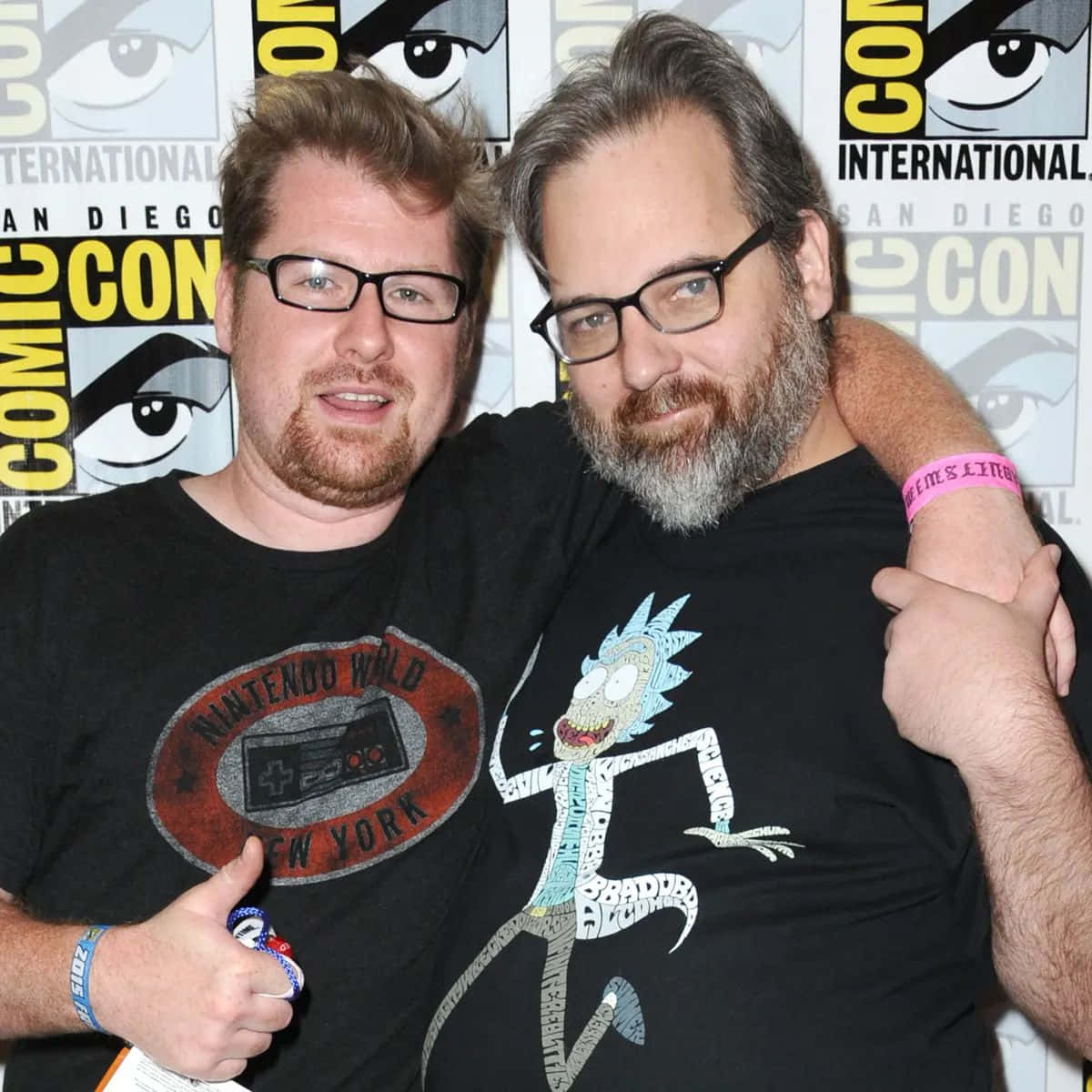 Justin Roiland posing with Rick and Morty's animated characters in the background. Wallpaper