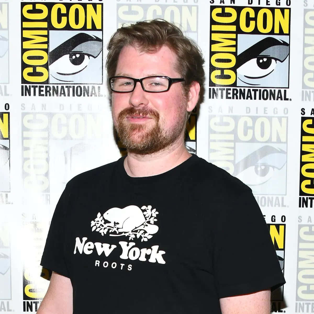Justin Roiland standing behind a creative drawing of Rick and Morty Wallpaper
