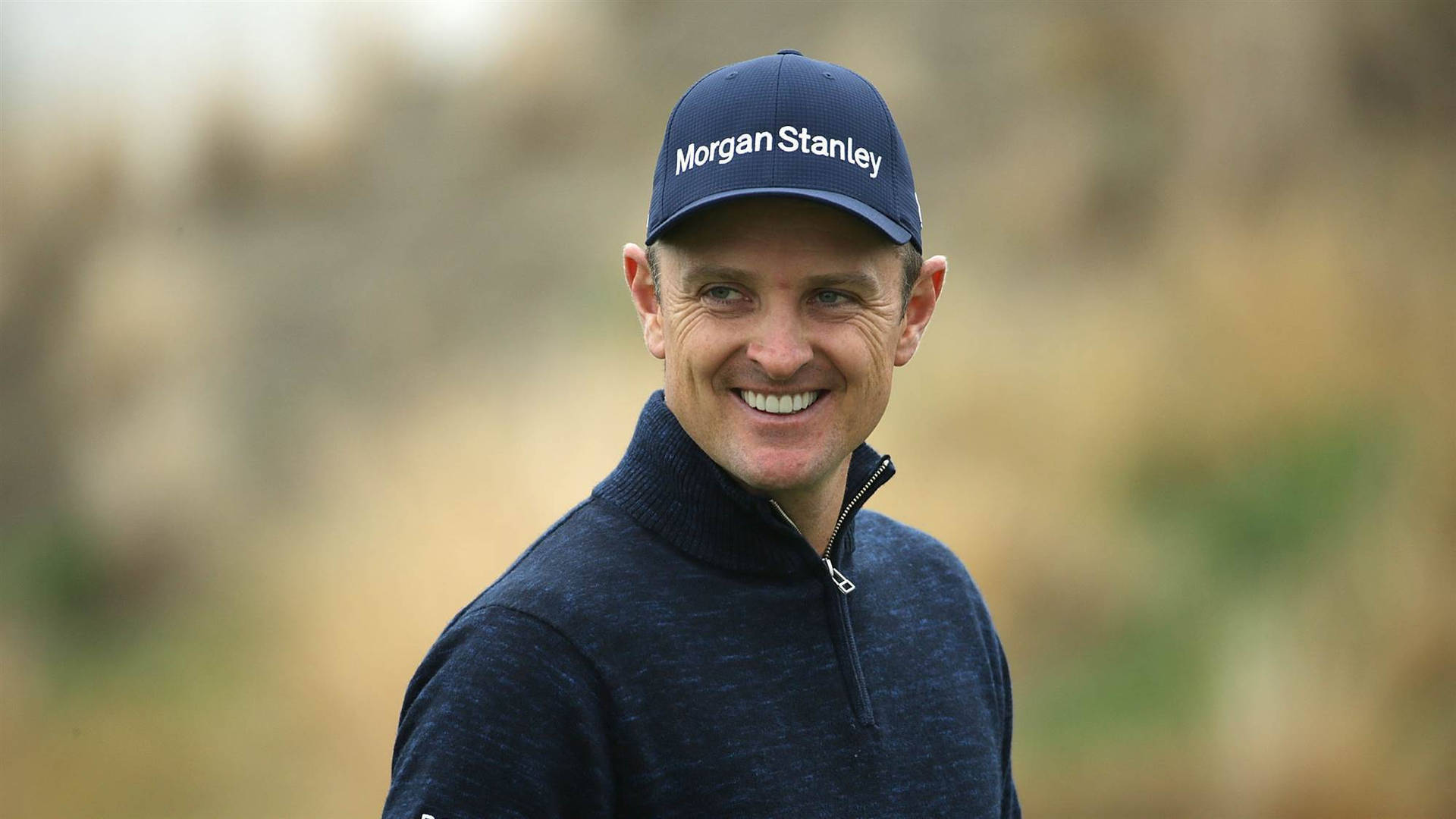 A Cheerful Justin Rose On The Golf Course Wallpaper