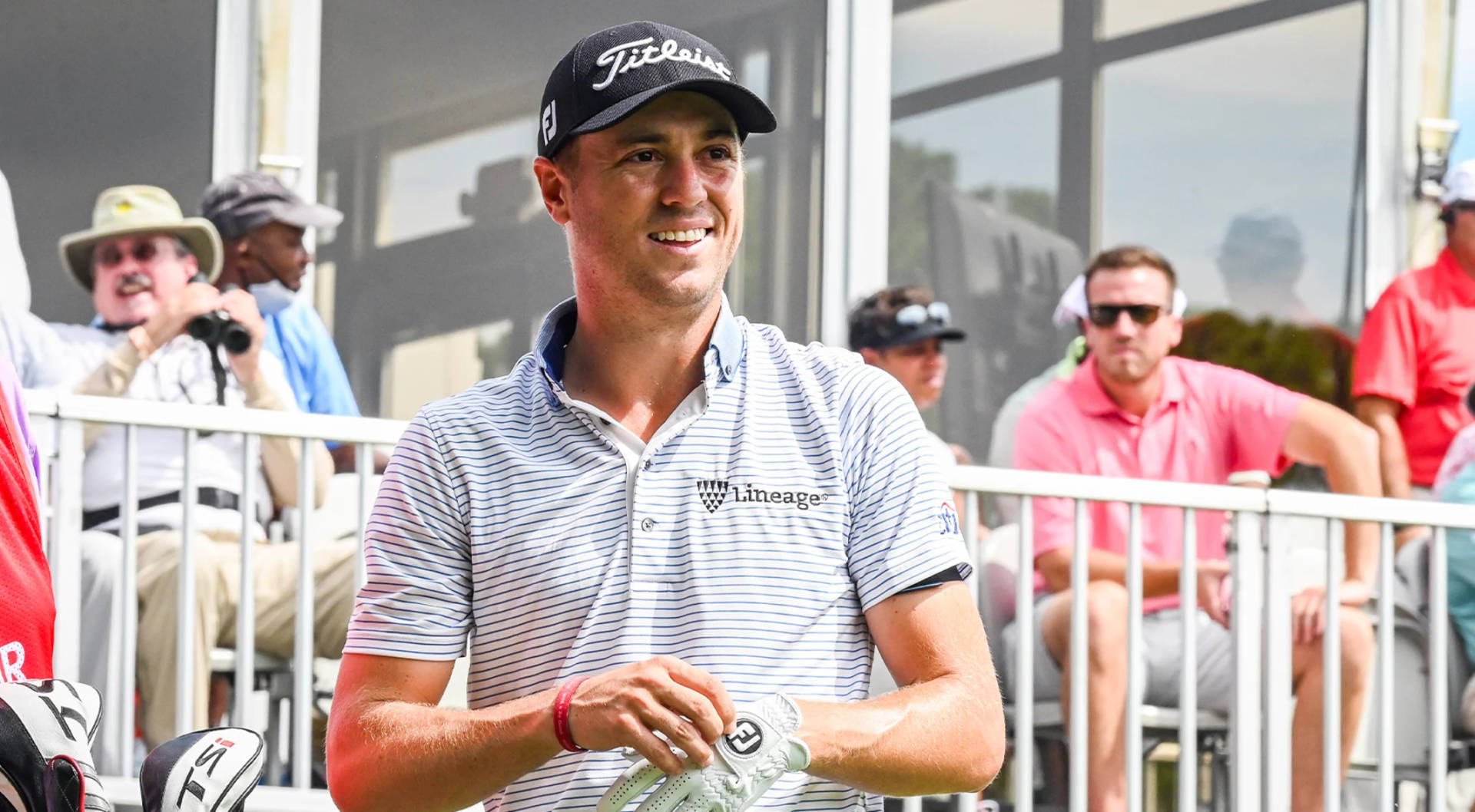 Caption: Justin Thomas Wearing A Striped Polo During Golf Tournament Wallpaper