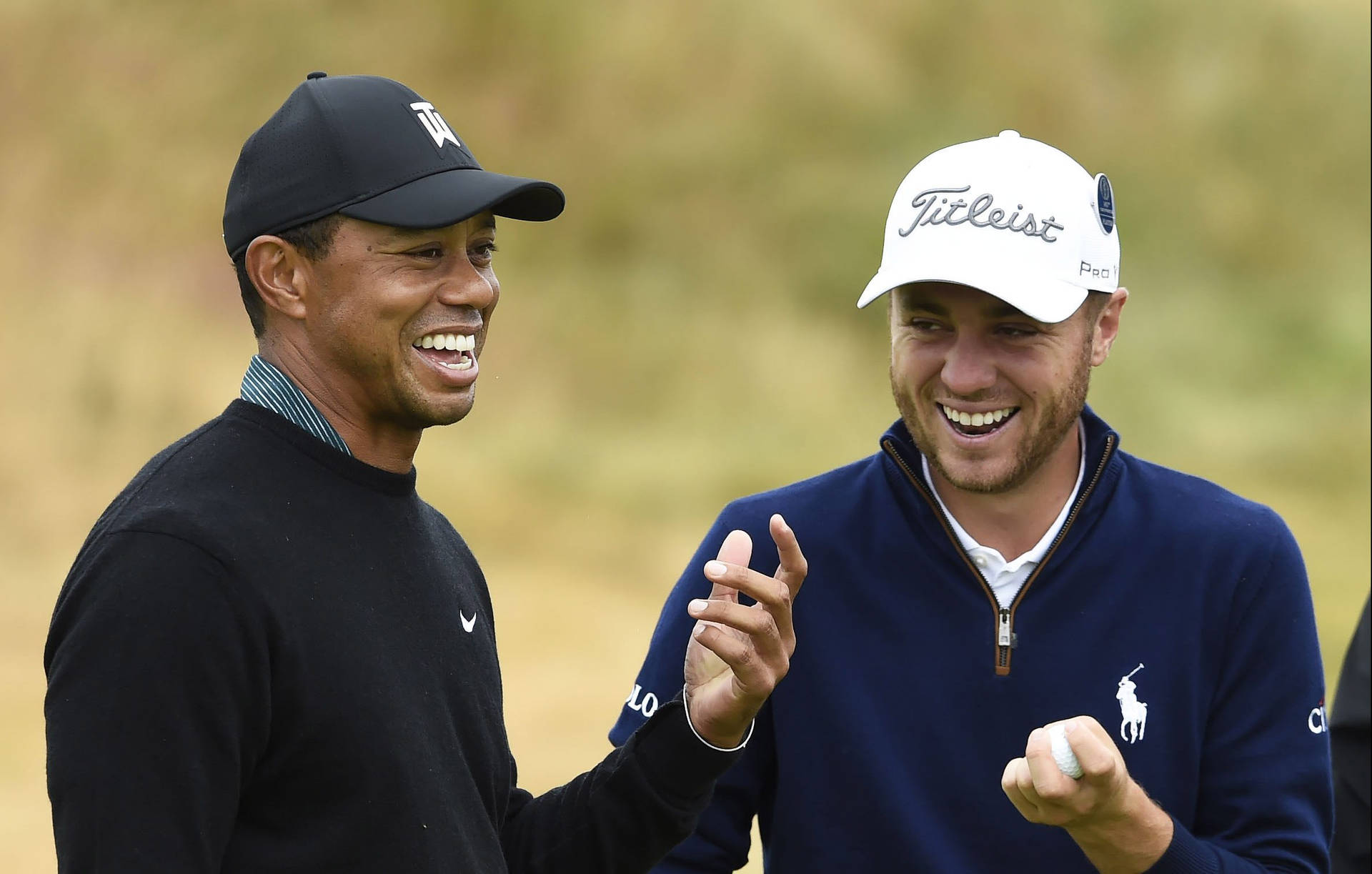 Justin Thomas Laughing With Tiger Woods Wallpaper