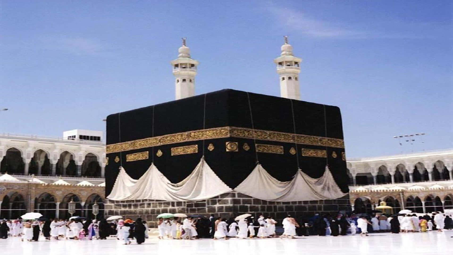 A Large Group Of People Standing Around A Kaaba