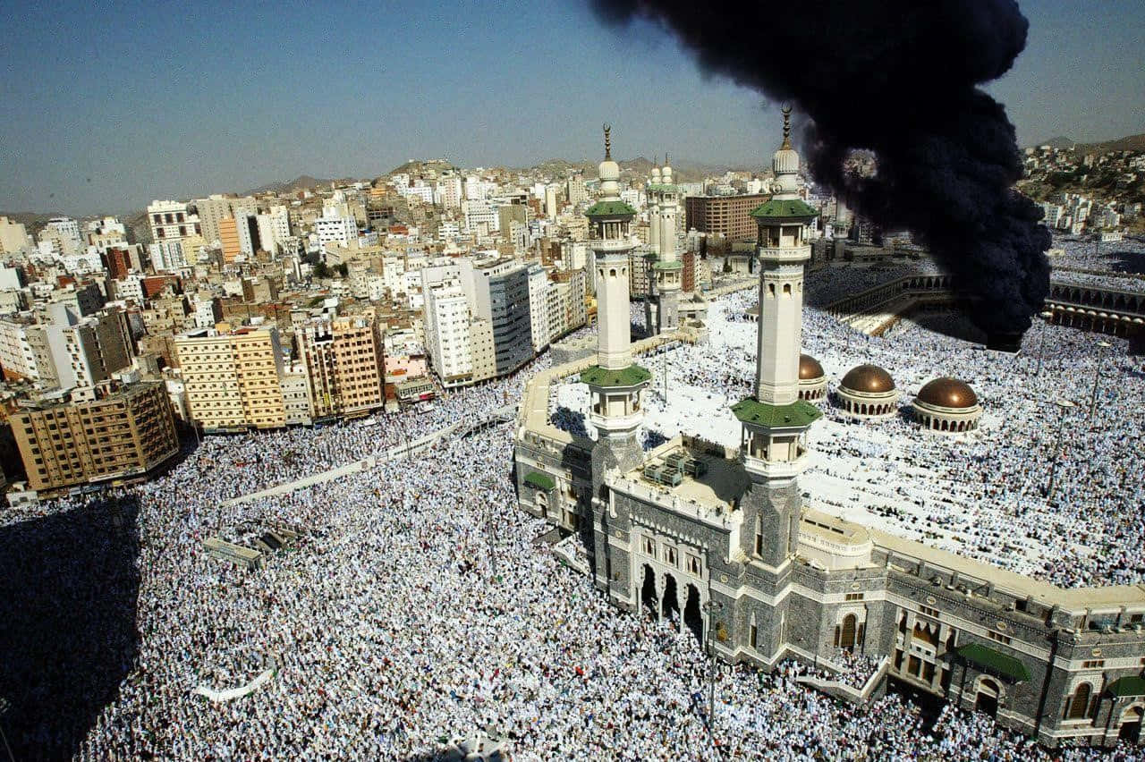 A Large Crowd Of People Gather Around The Grand Mosque