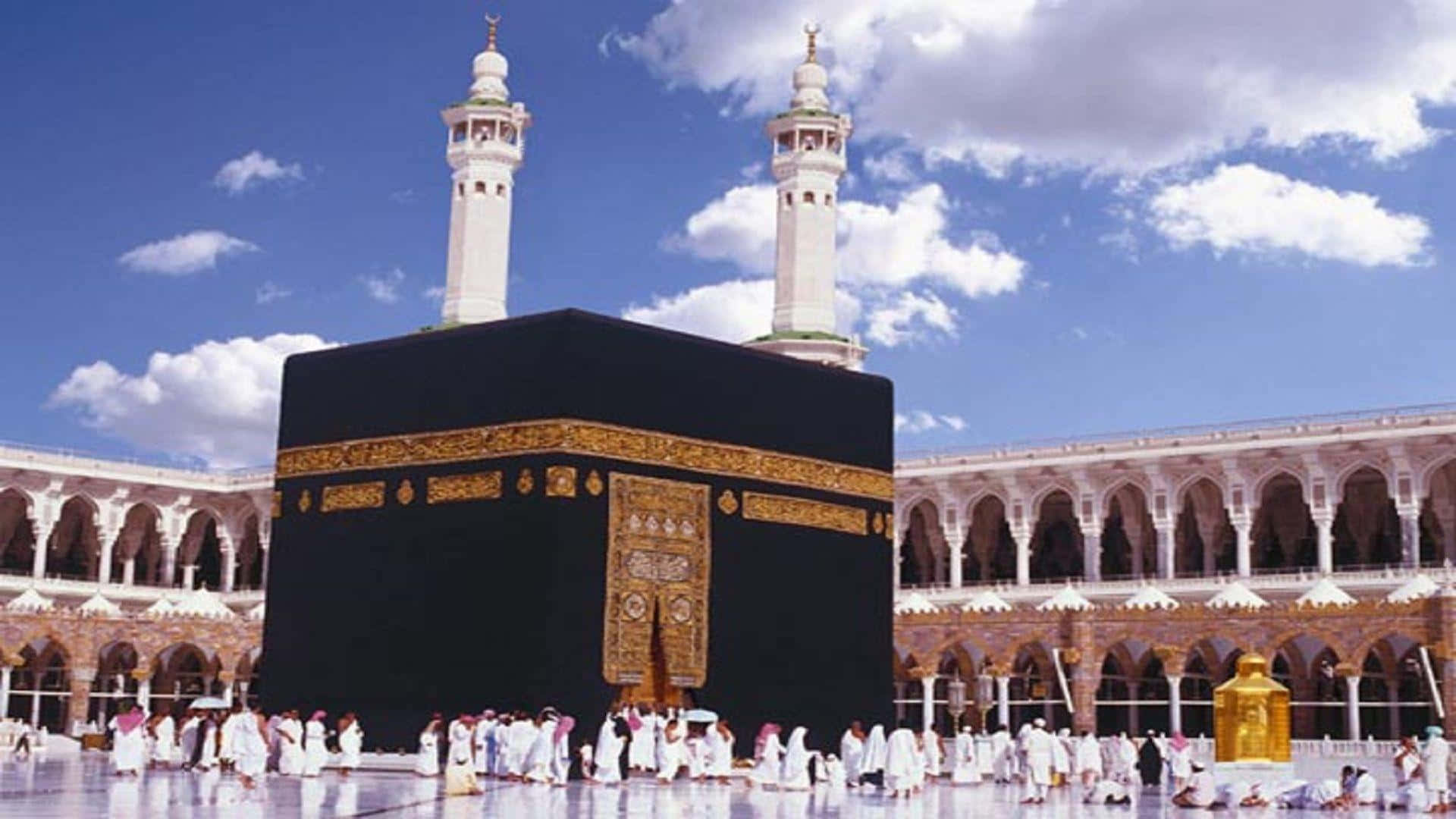 A Group Of People Standing Around A Kaaba