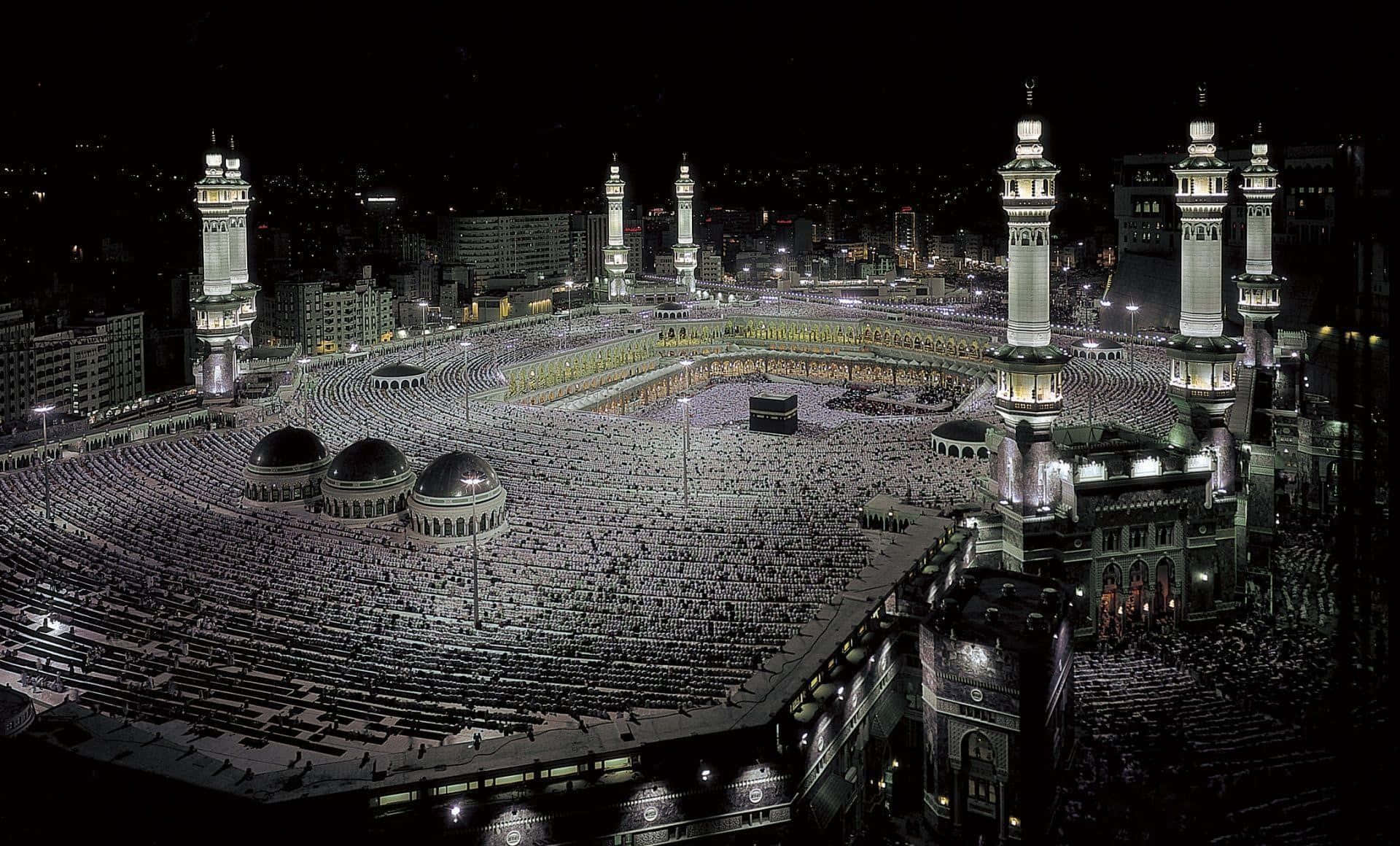 The Kaaba At Night With Many People Around It