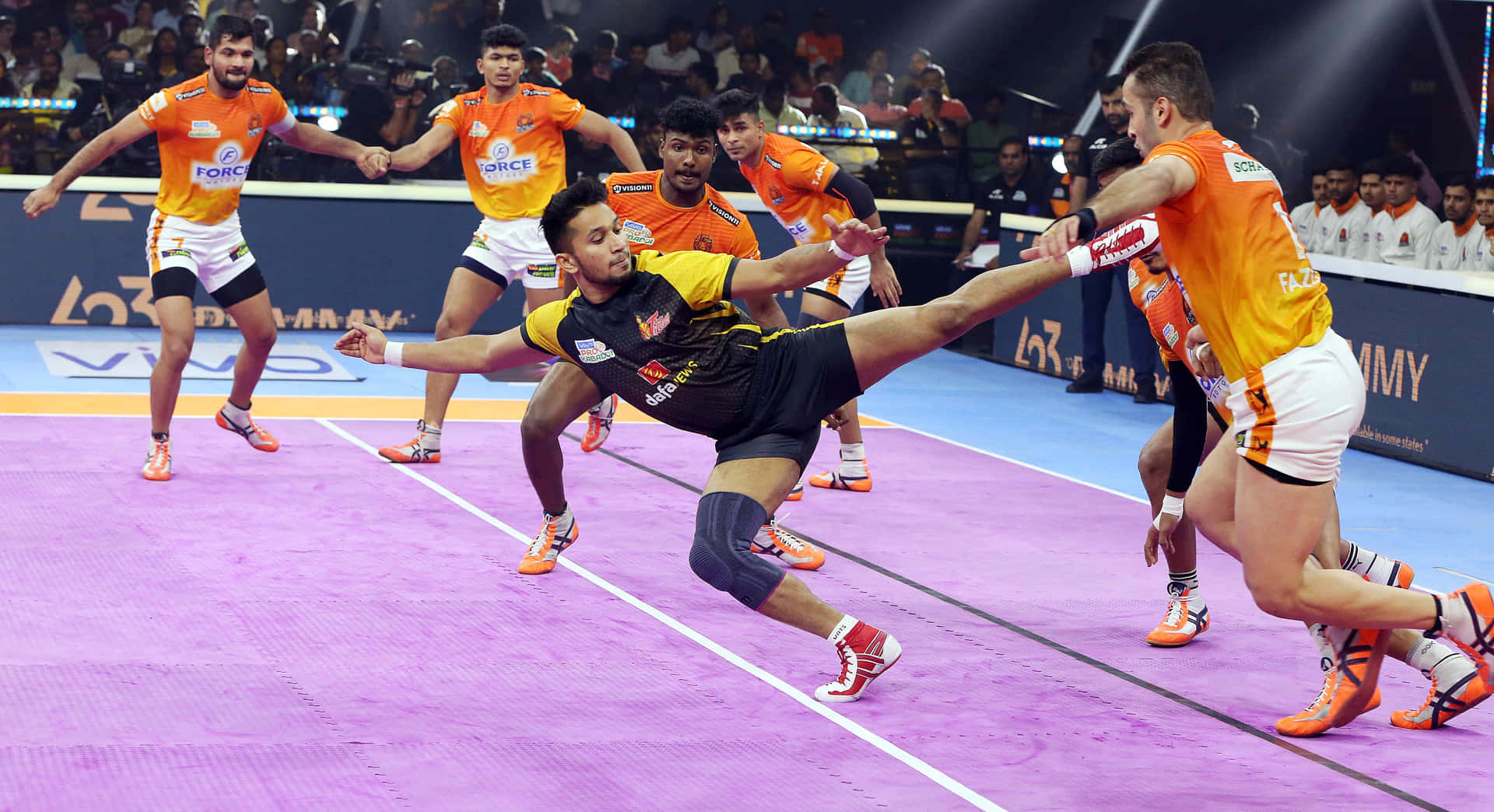 Kabaddi players in action on the court
