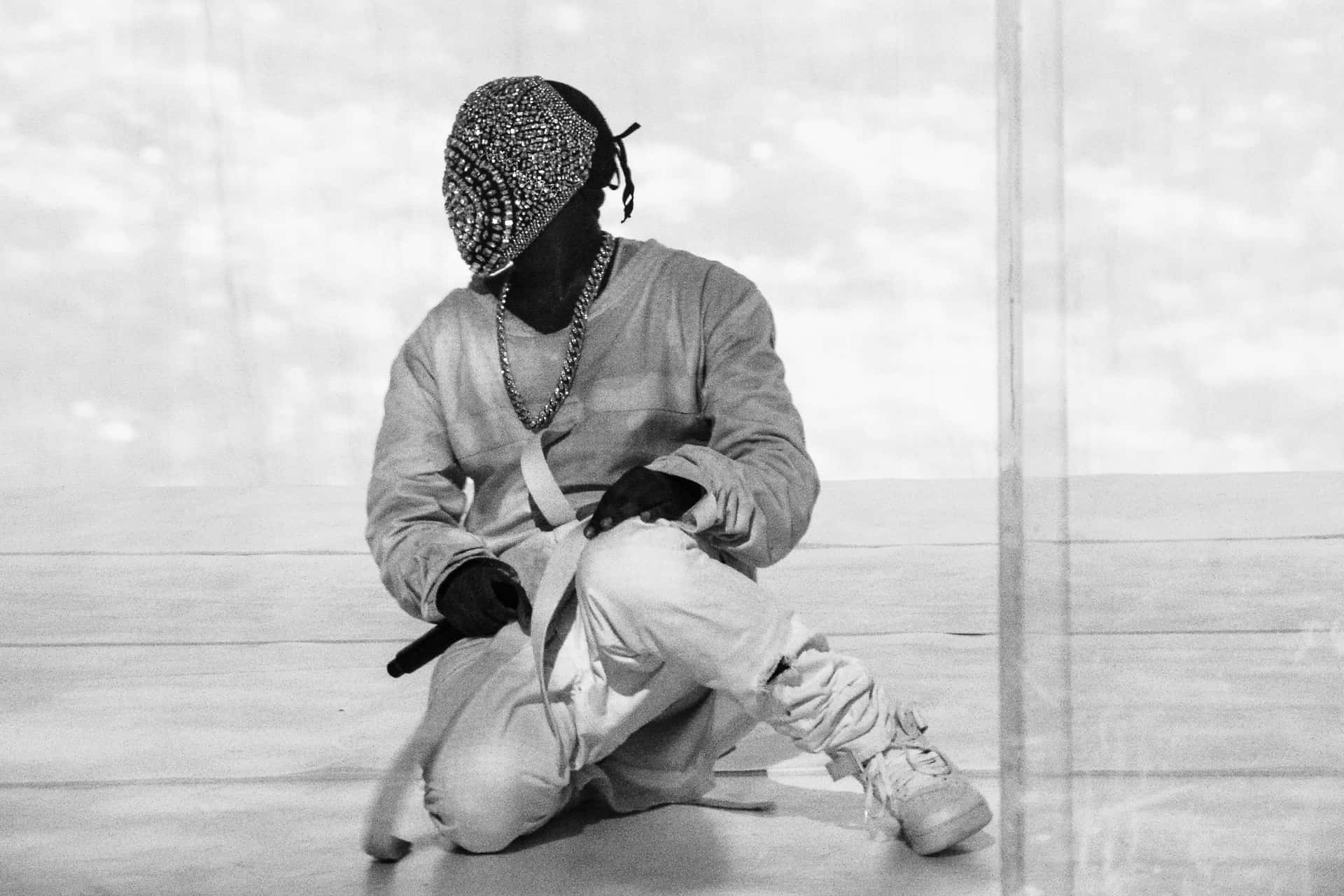 Kanye West poses with Yeezus album artwork. Wallpaper