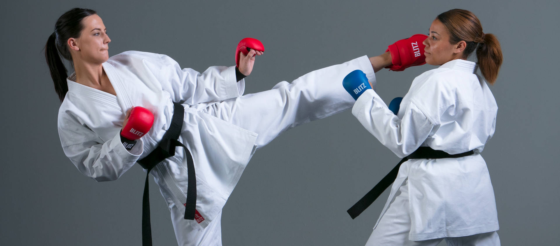 Caption: Dynamic Karate Action Between Two Female Martial Artists Wallpaper