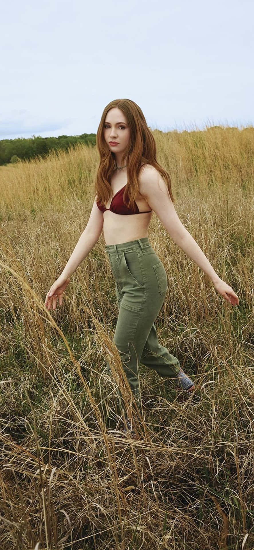 A Woman In A Bikini Standing In A Field Wallpaper