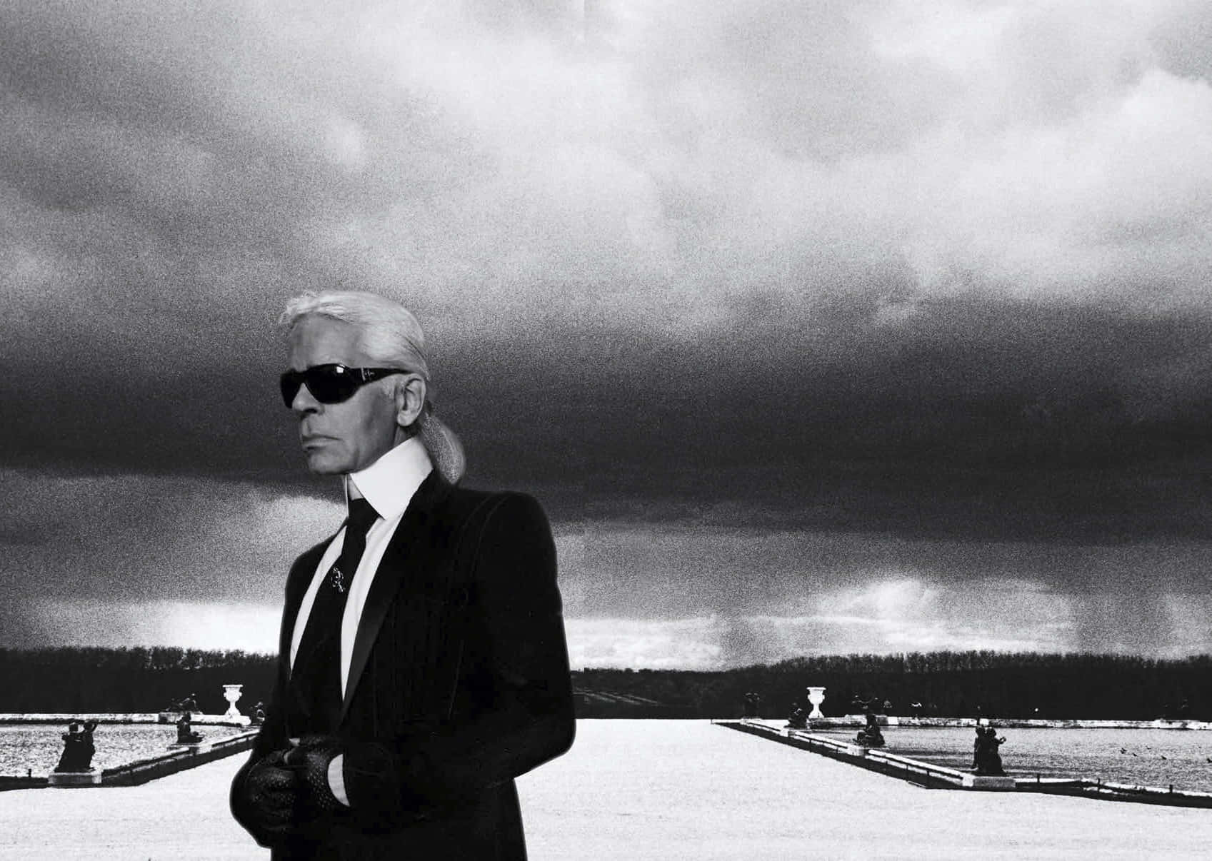 “Iconic fashion designer Karl Lagerfeld seen in a classic leather jacket and glasses.” Wallpaper