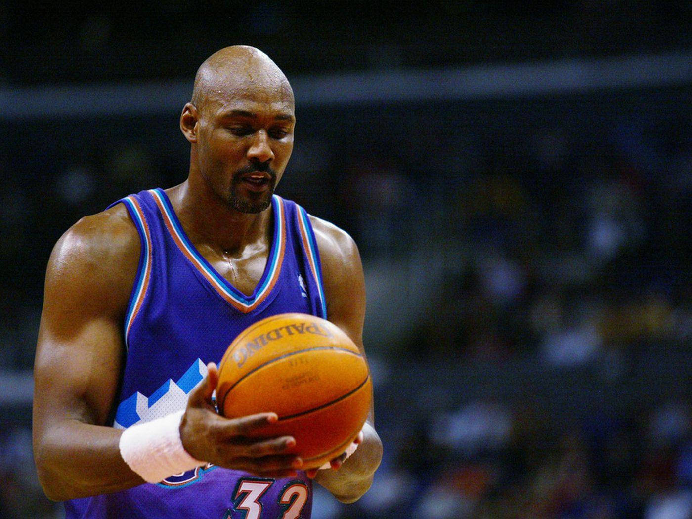 Karl Malone A Former American Basketball Player Holding A Ball Wallpaper
