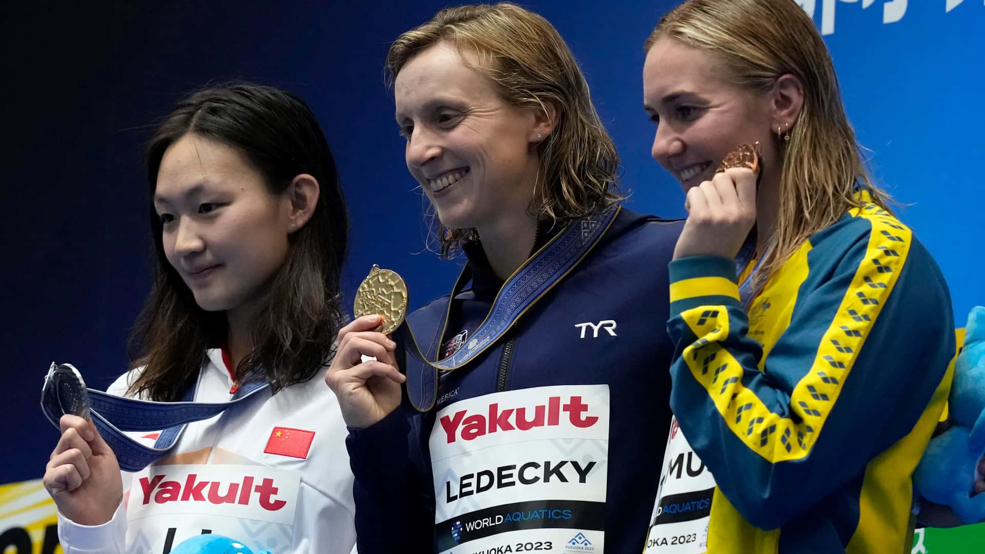 Katie Ledecky Celebrating Victory With Competitors Wallpaper