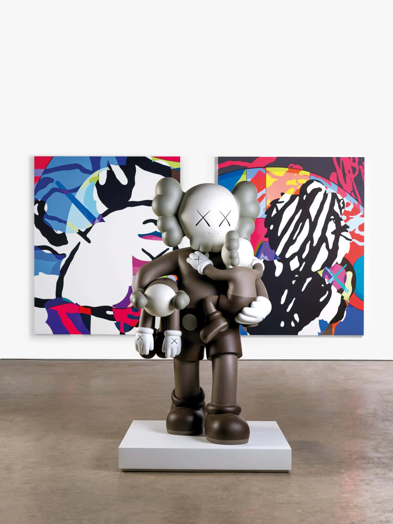 A Collection of Vibrant KAWS Figures Displayed Together Wallpaper