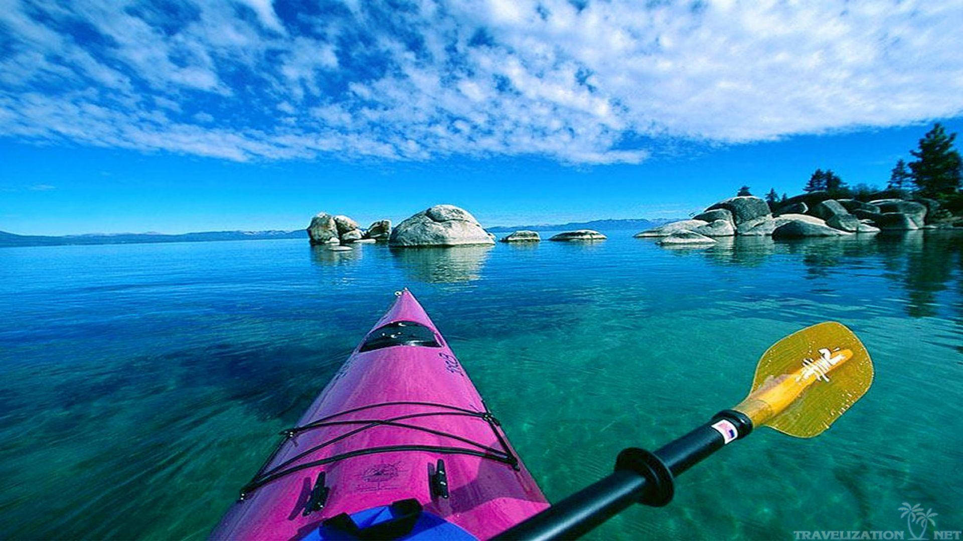 Kayaking By A Rock Formation Wallpaper