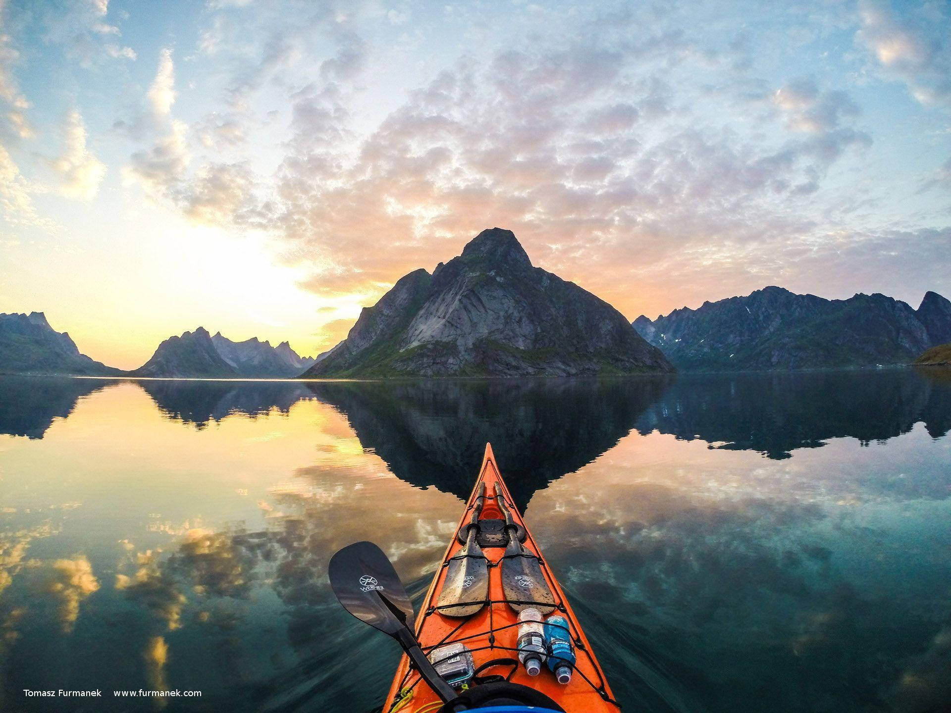 Kayaking Over Reflective Water Wallpaper