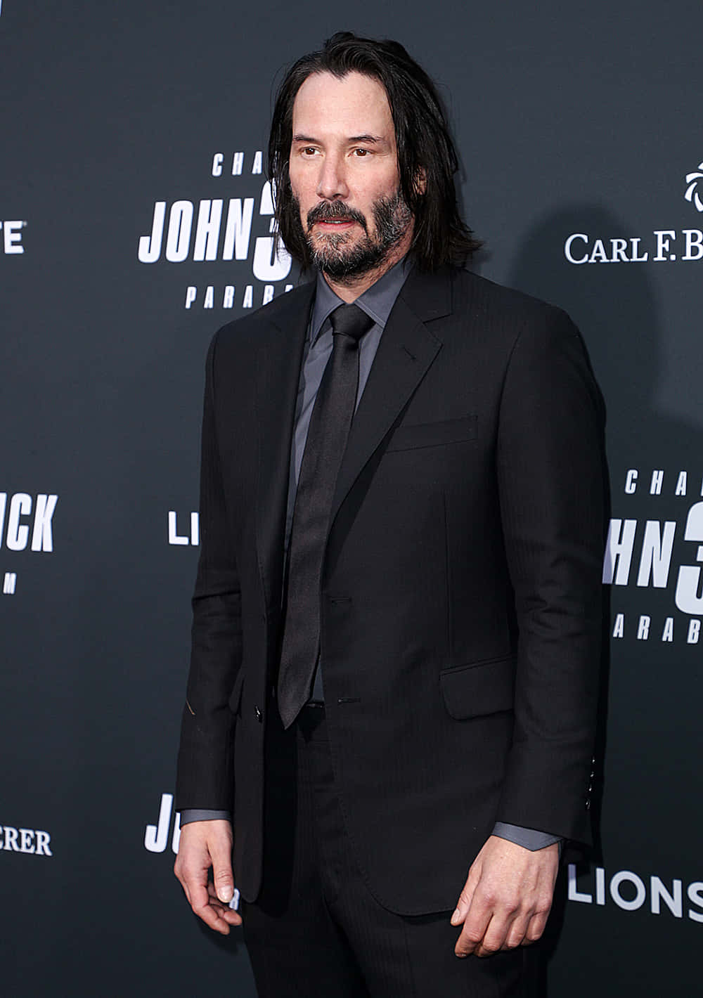 Keanu Reeves exudes charm and style in an elegant suit