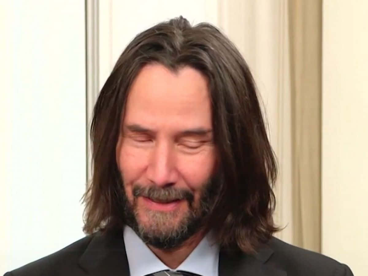 Keanu Reeves in a stylish pose