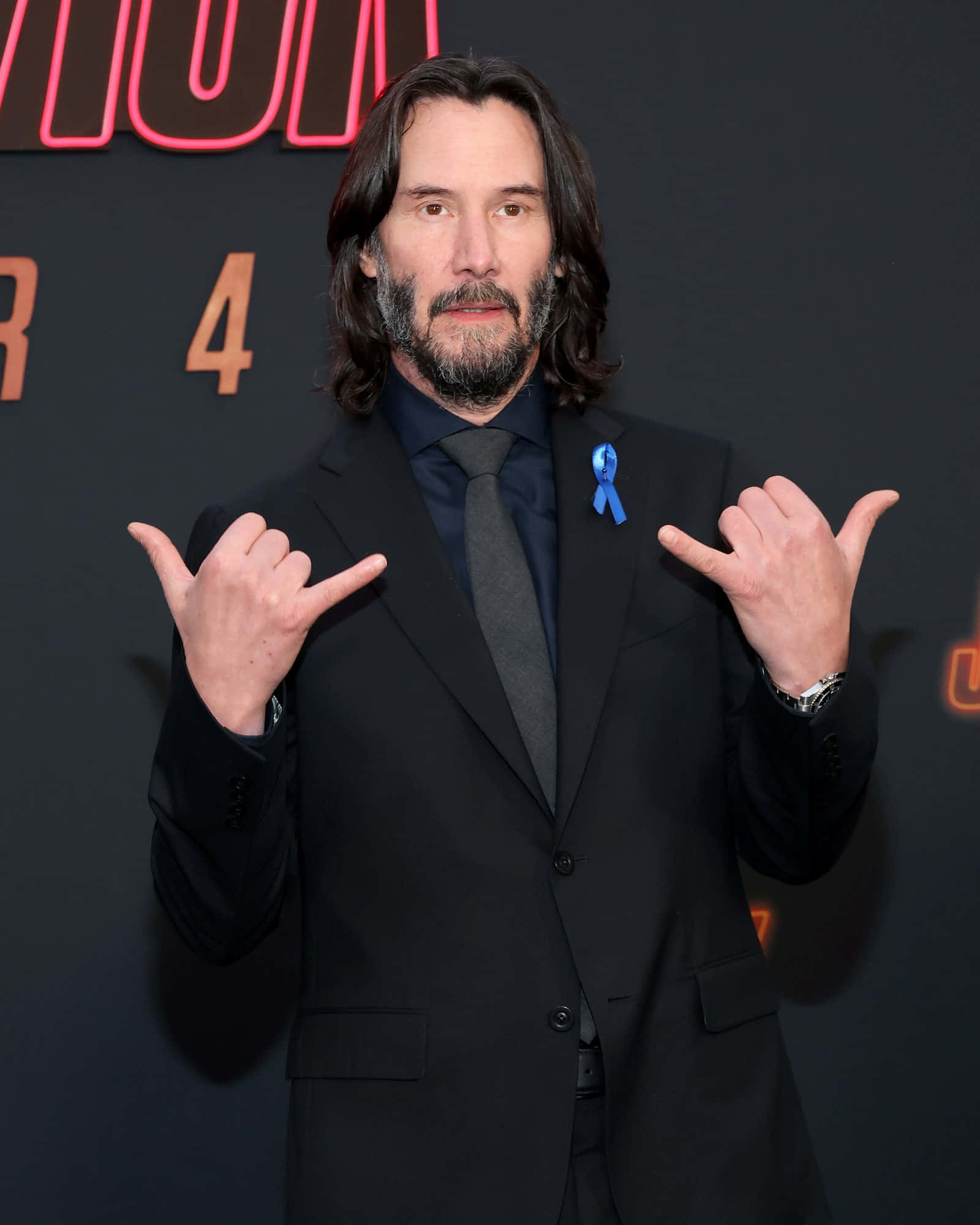 Keanu Reeves striking a pose in a stylish outfit